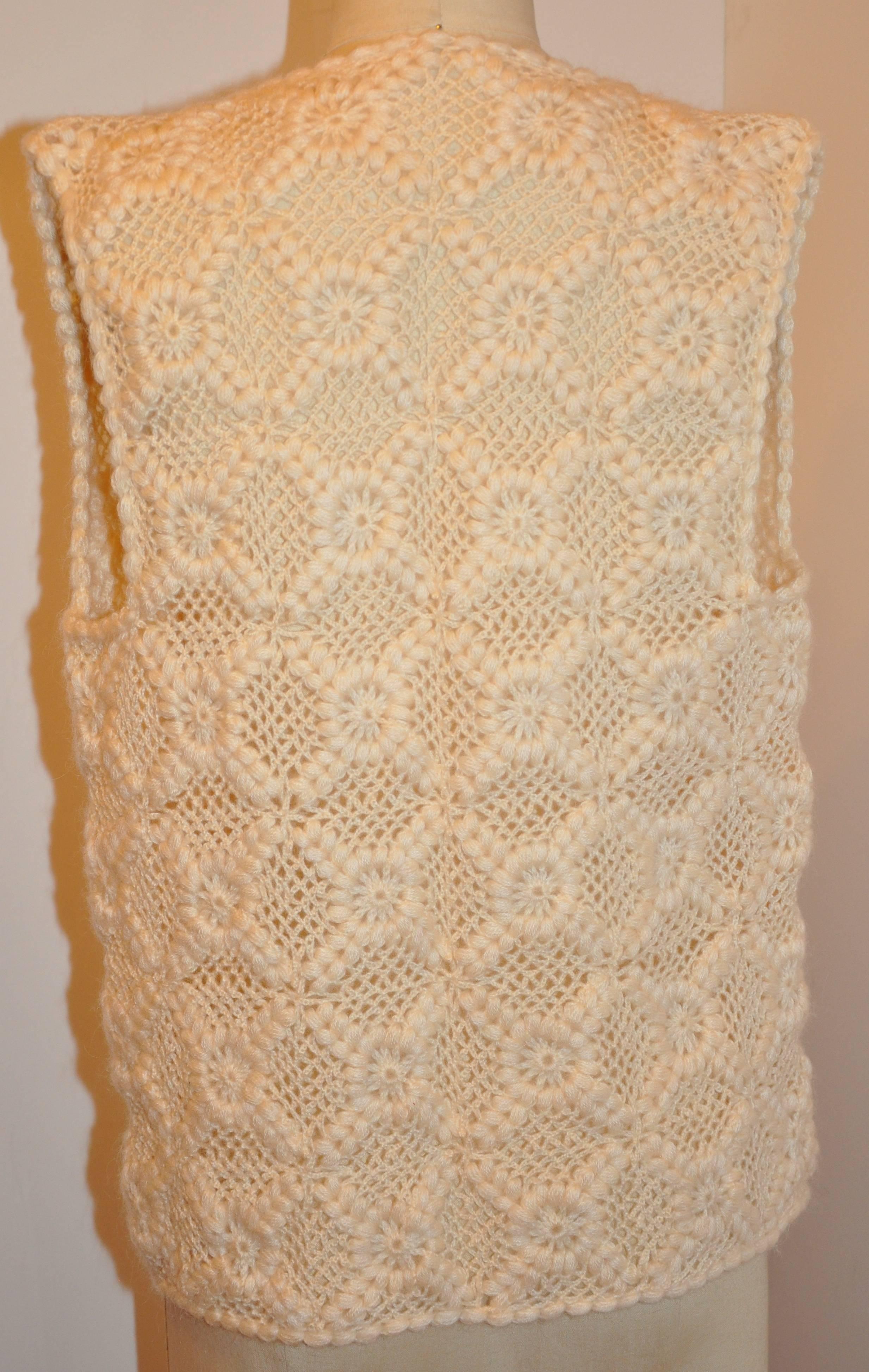       This wonderfully buttery soft front tie vest of angora blend is hand crochet detailed with hand embroidered stitches. Each square measures 3