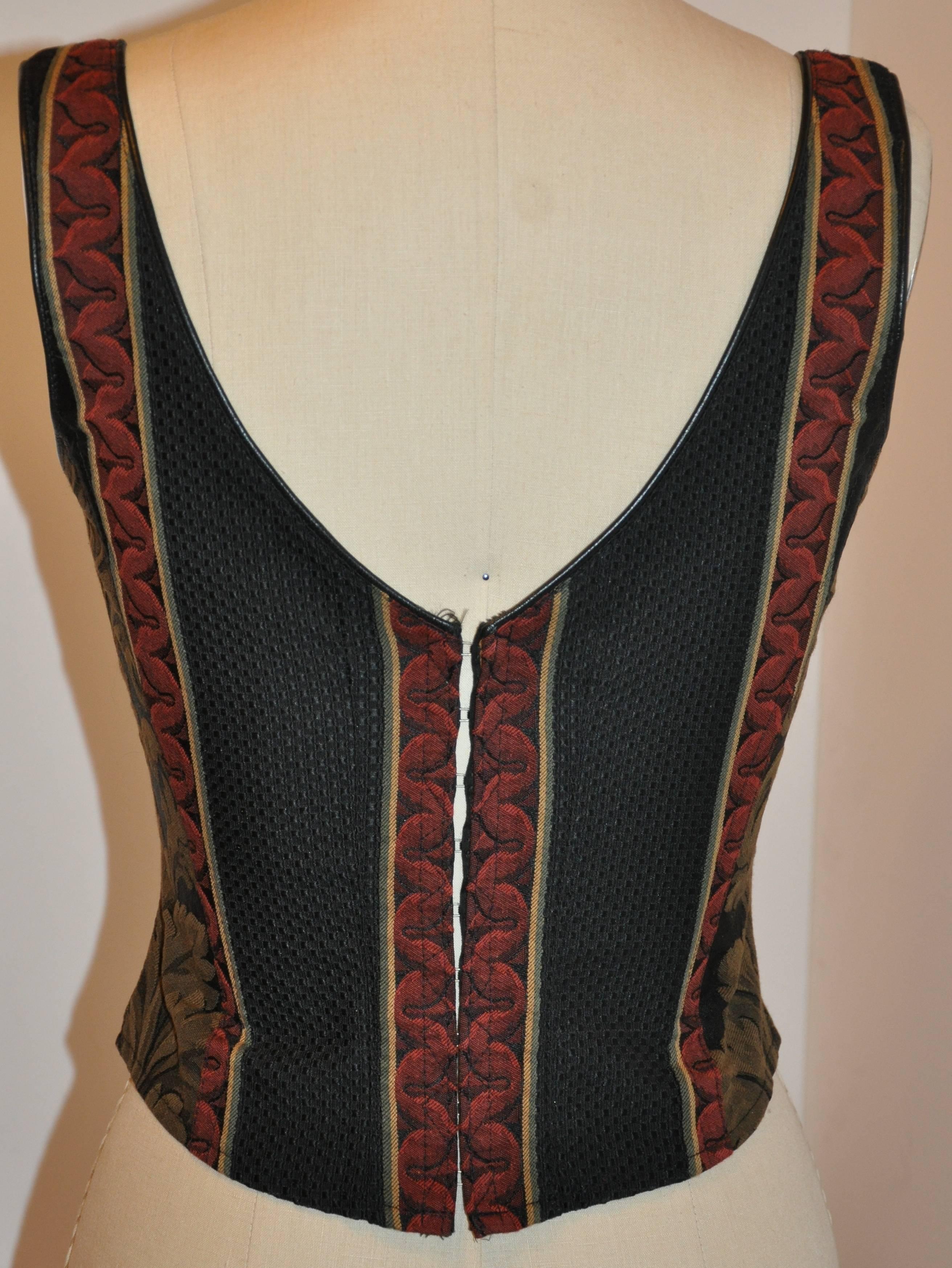        Gigi Clark's wonderfully detailed multi-color corset has a adjustable lace-up front with a row of 15 eyelet accented with a black silk cord. The back is accented with a row of 9 hook and eye with black lambskin leather edge finish throughout
