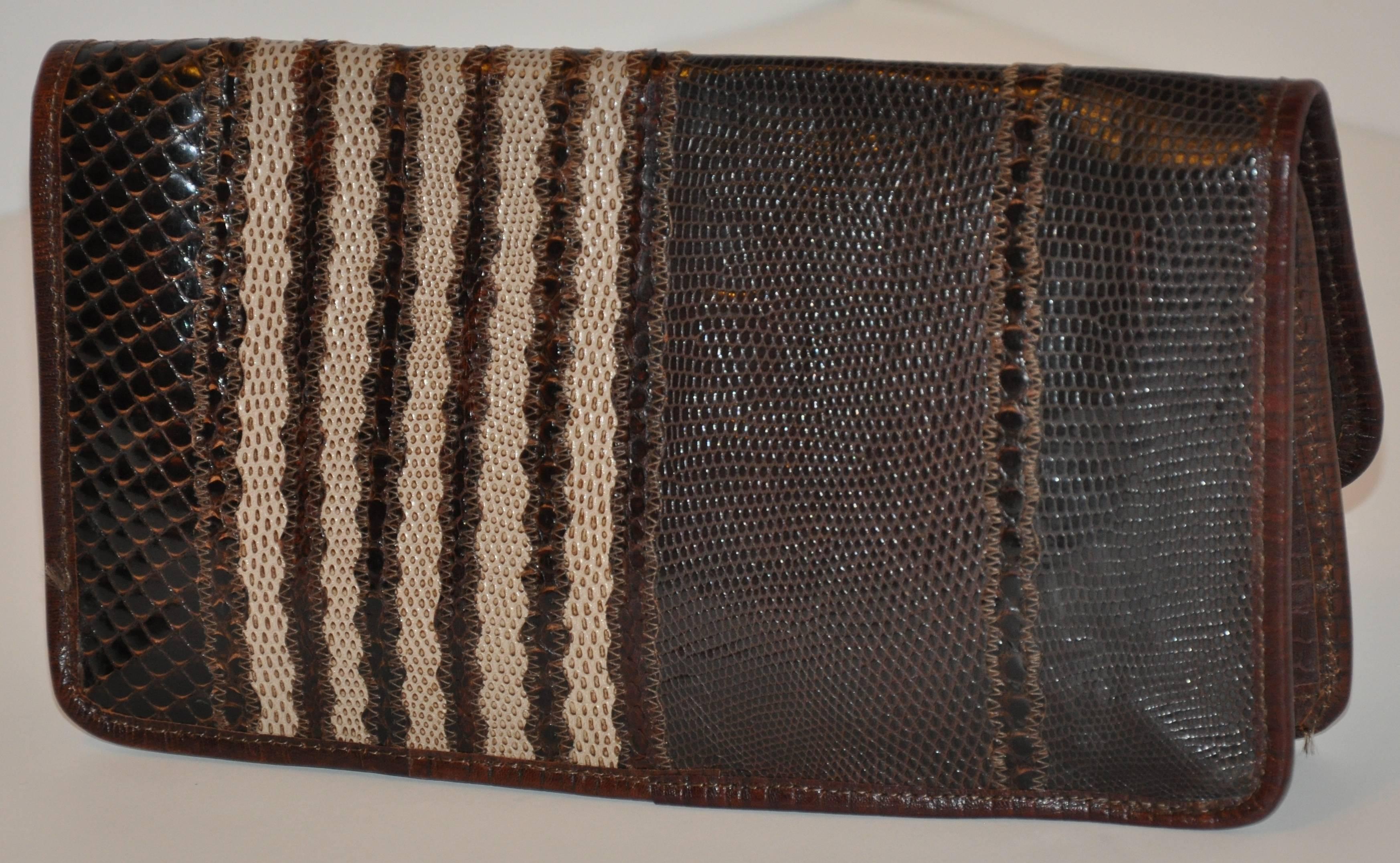        As only Carlos Falchi can, This wonderful multi-texture combination of lizard, snake and pylon skin finished with lambskin leather piping along the edges as well as the interior lining with shades of coco brown and browns. This wonderful