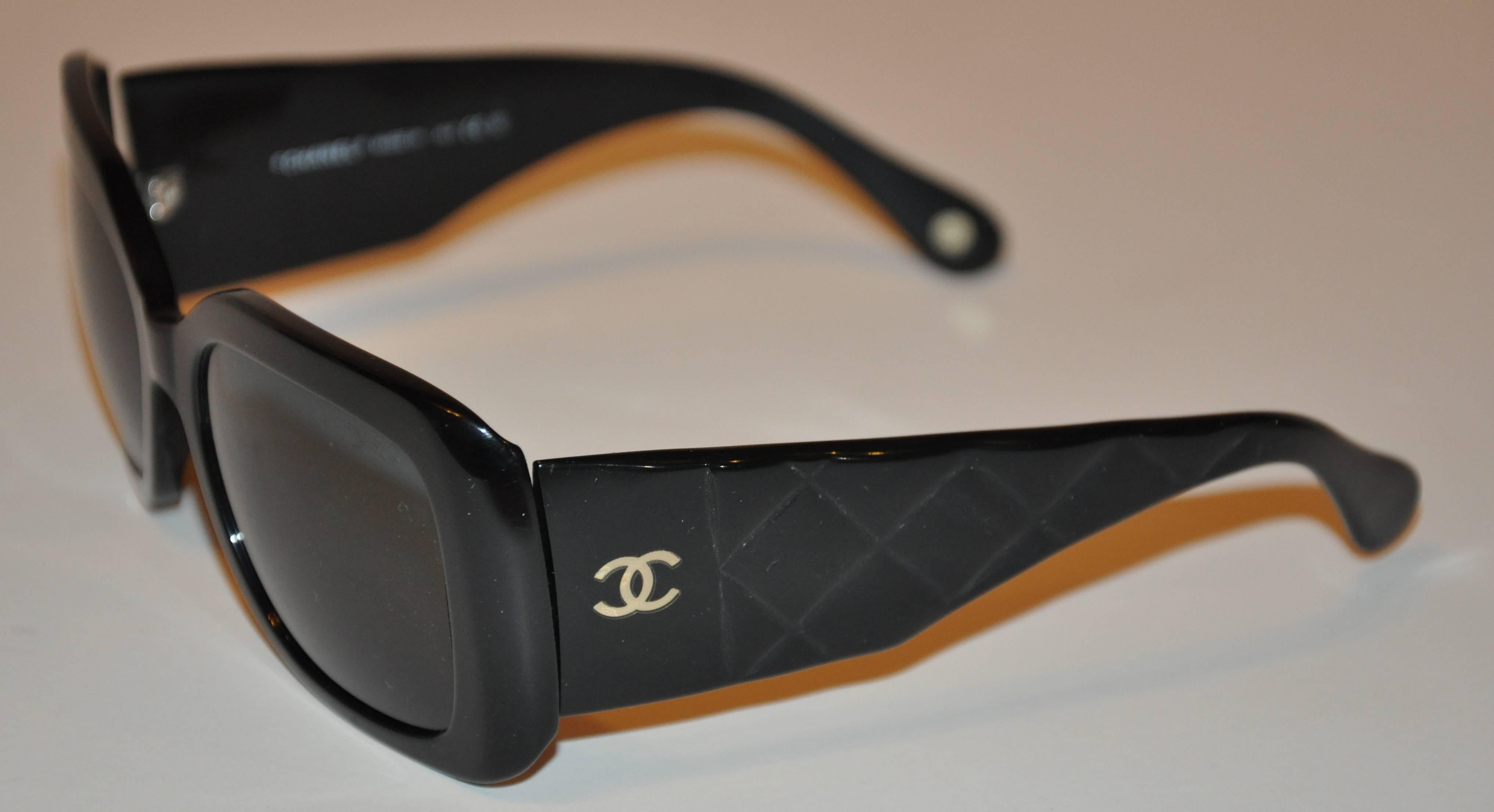        Chanel large thick black lucite sunglasses are accented with 