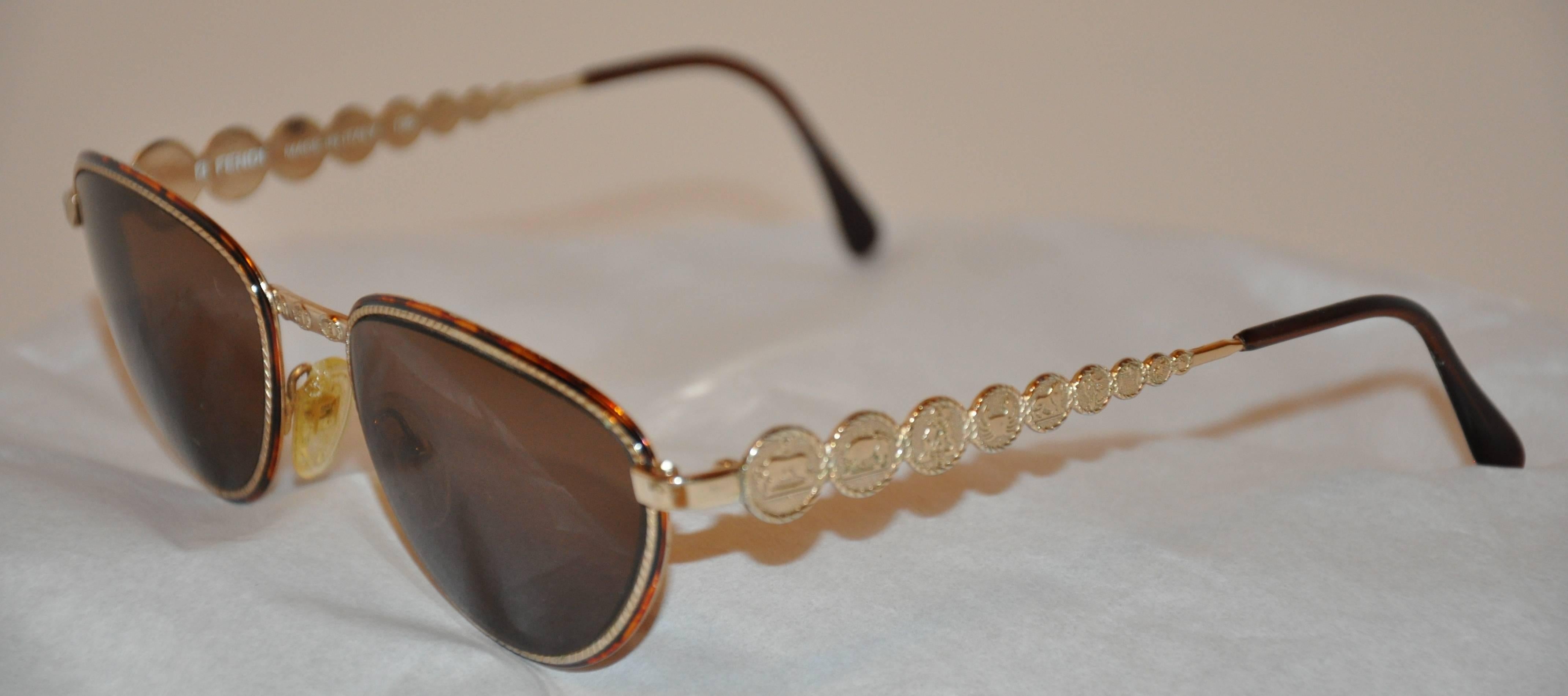        This wonderfully rare detailed Fendi gilded gold sunglasses are etched with signs of the 