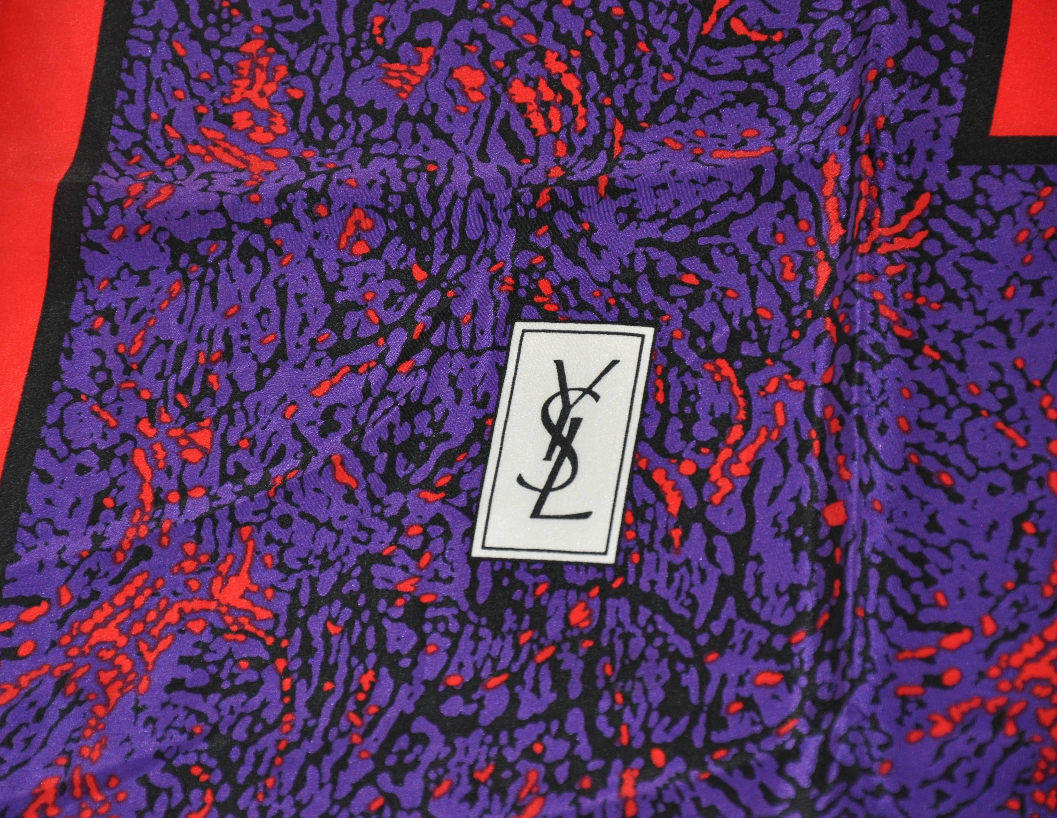        Yves Saint Laurent  bold multi-color silk scarf is finished with hand-rolled edges and measures 34