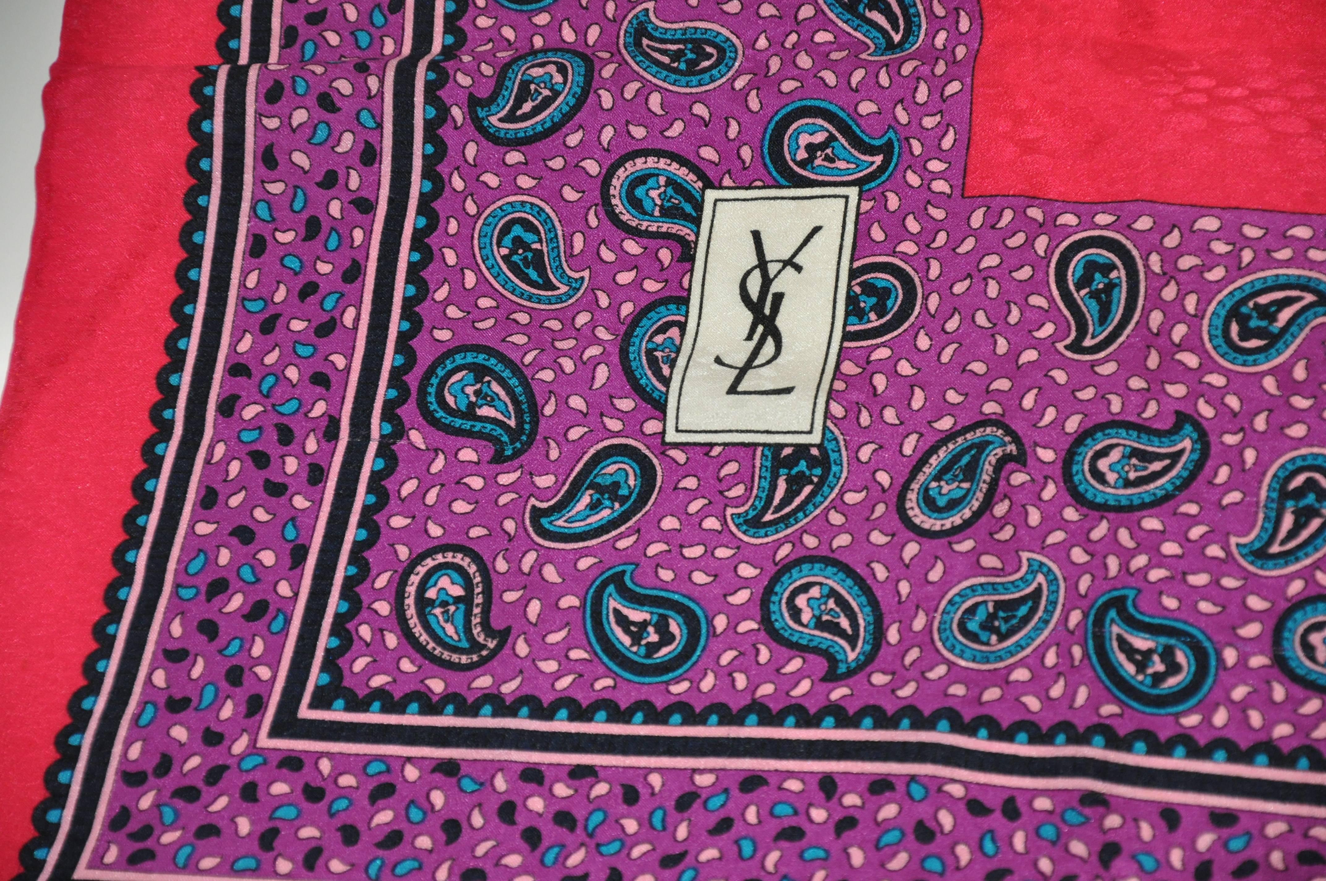        Yves Saint Laurent wonderful silk crepe di chine in colors of fuchsia, purple, black and cream is accented with borders of palsey print and finished with hand-rolled edges. This wonderfully elegant scarf measures 35