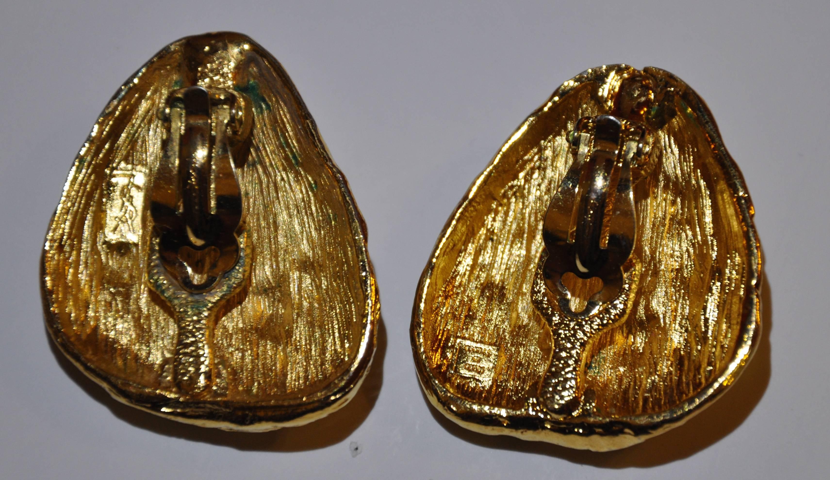        Yves Saint Laurent wonderfully multi "Nugget" huge gilded gold tone with a vermeil finished clip on earrings has the signature YSL engraved on the back. These earrings measures 1 3/4" in height and  1 1/2" in width. The