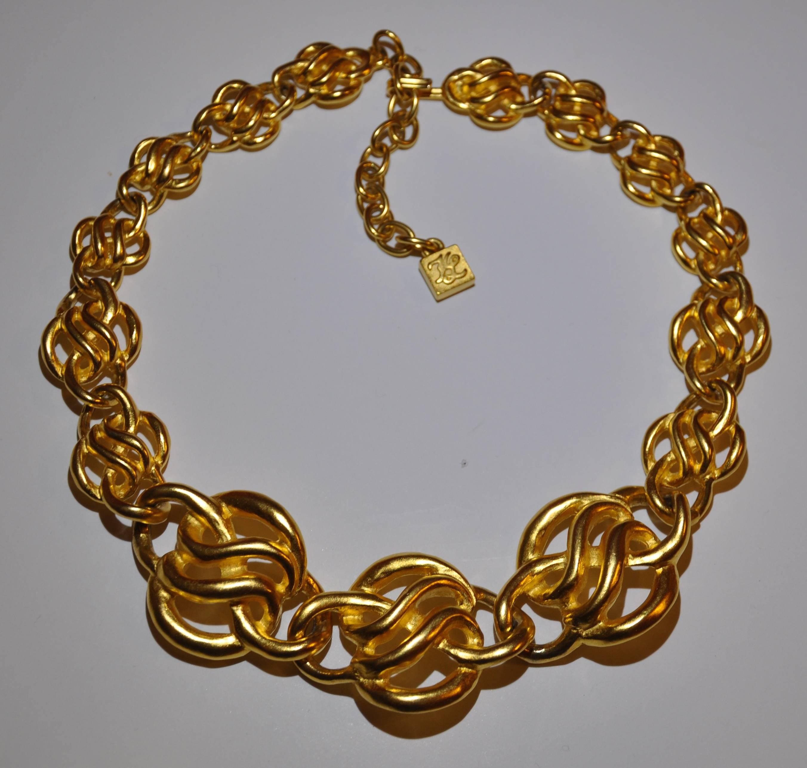      Karl Lagerfeld wonderful polished gilded gold tone adjustable necklace finished in a vermeil measures18 1/2" in total length. The width measures from 1 3/8" at the widest to 5/8" at the slimmest width. 