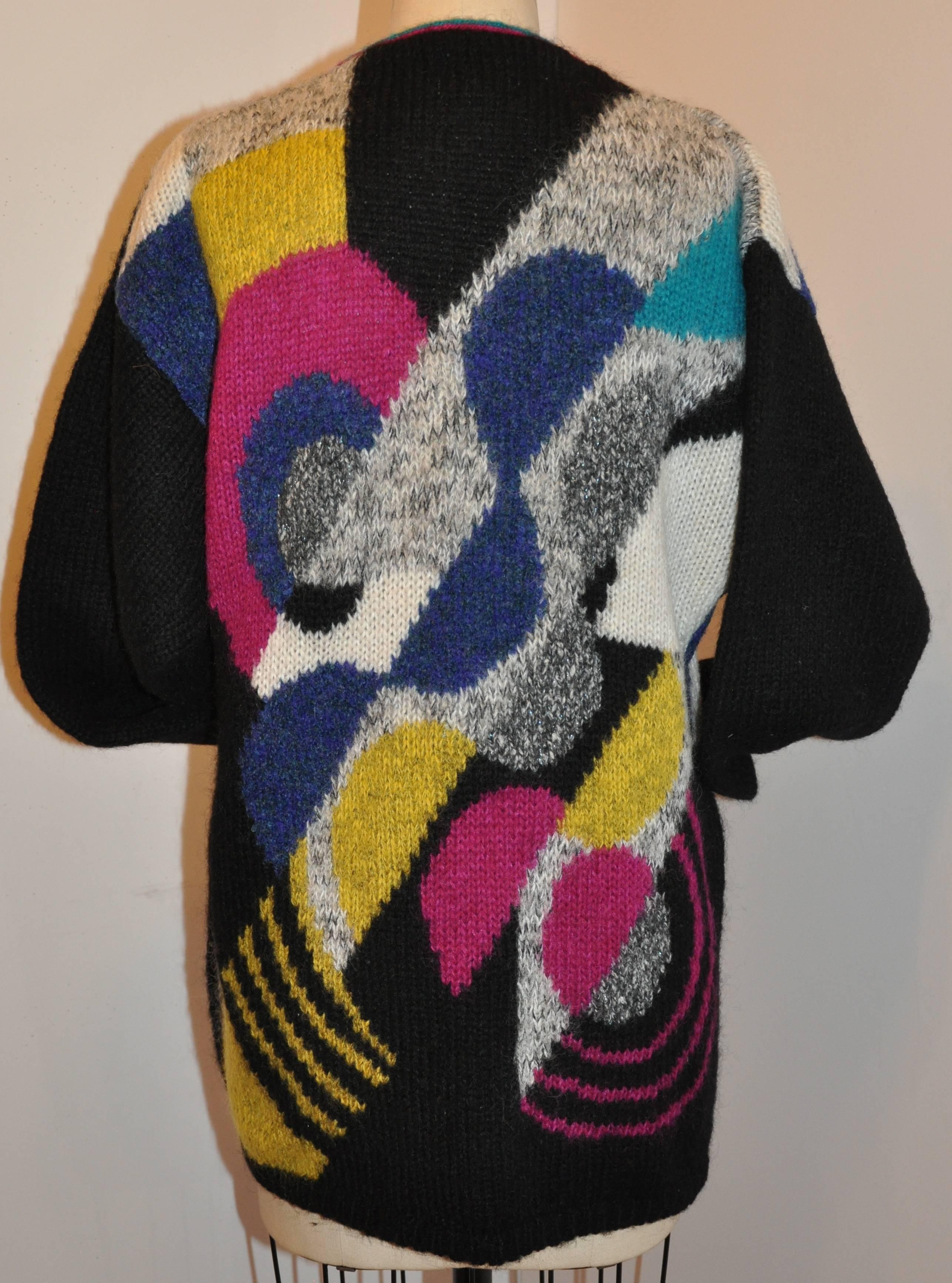      Cervelle wonderful multi-color bold abstract woven blend of wool, acrylic, mohair and nylon three button front cardigan is detailed with two set-in front pockets. The shoulders measures 21