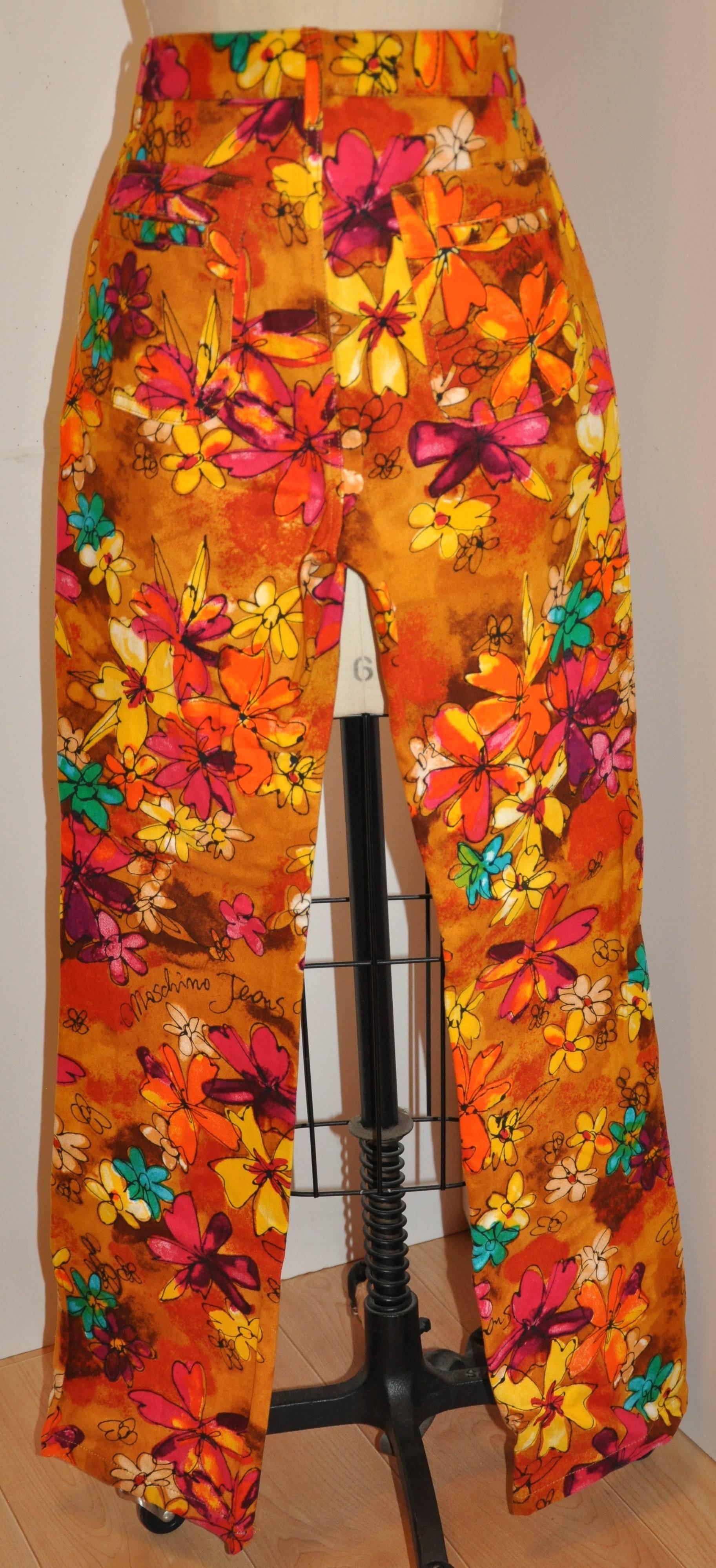        Le jean en coton brossé Moschino à imprimé floral multicolore est conçu avec un devant plat et deux poches frontales cachées le long de la taille. Le dos comporte deux poches plaquées, accentuées par deux poches encastrées sur le dessus. La