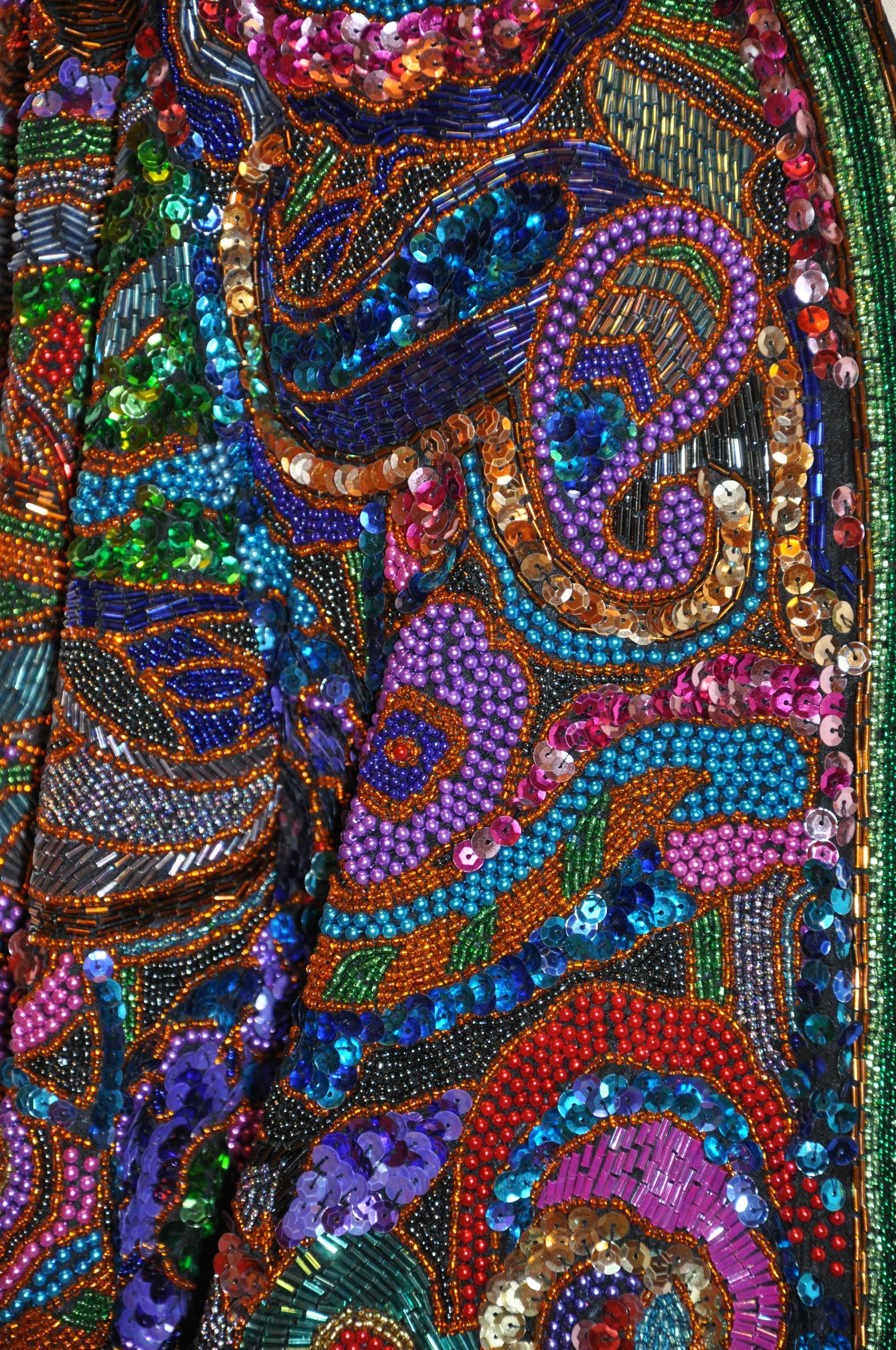         Diane Frez's wonderfully detailed evening open jacket with multi-colors of multi-beaded micro combinations of pearls, bugle and seed bead work accented with micro sequins and textures makes for quite an elegant evening jacket. The shoulder