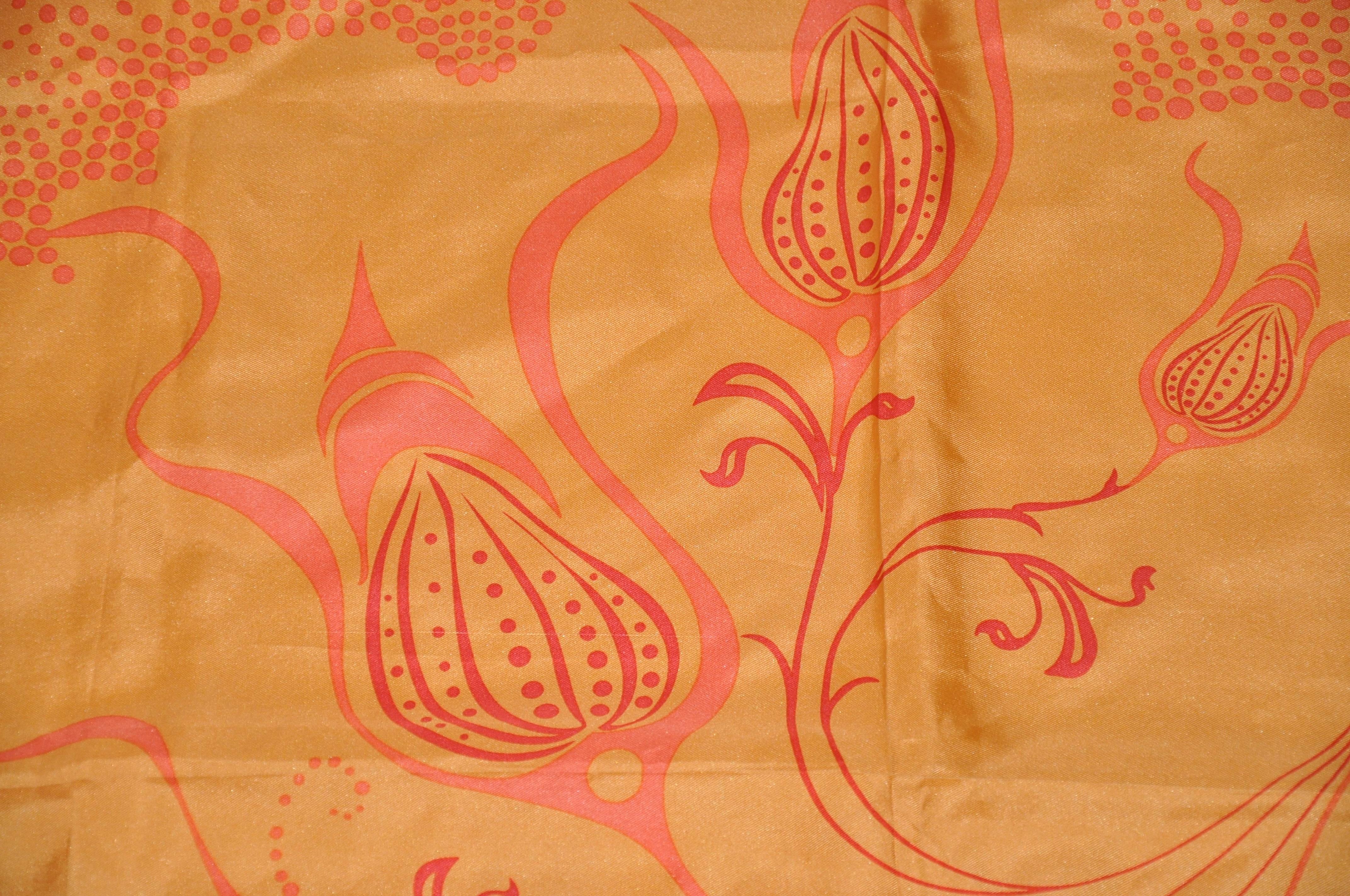        This wonderfully warm tangerine with "orange swirls" silk  jacquard scarf is finished with hand-rolled edges and measures 34" x 35". Made in Italy.