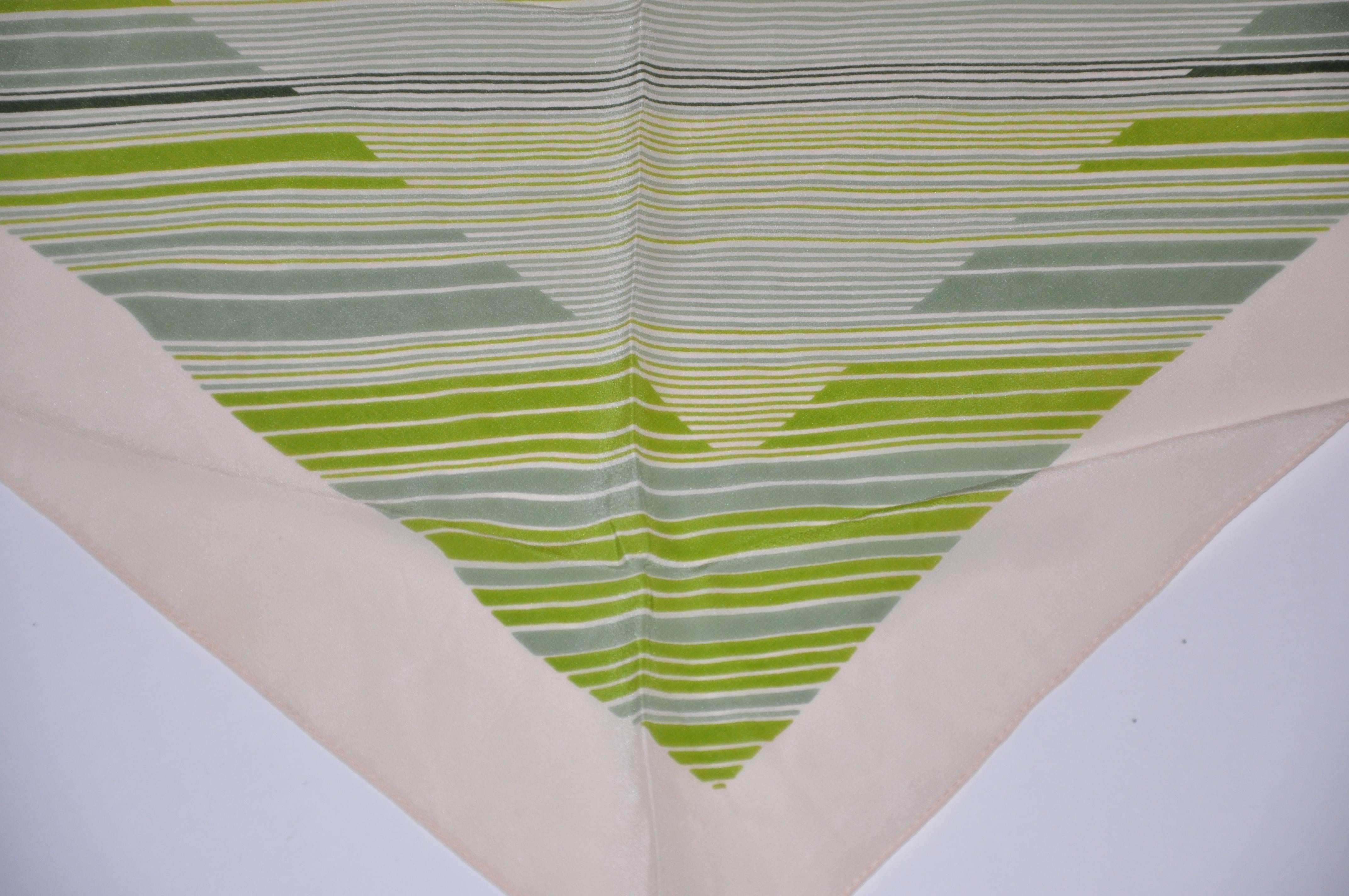 Geoffrey Beene beige border accented with multi-green stripes triangle silkscarf measures 24" x 54". Made of silk and made in Japan.
