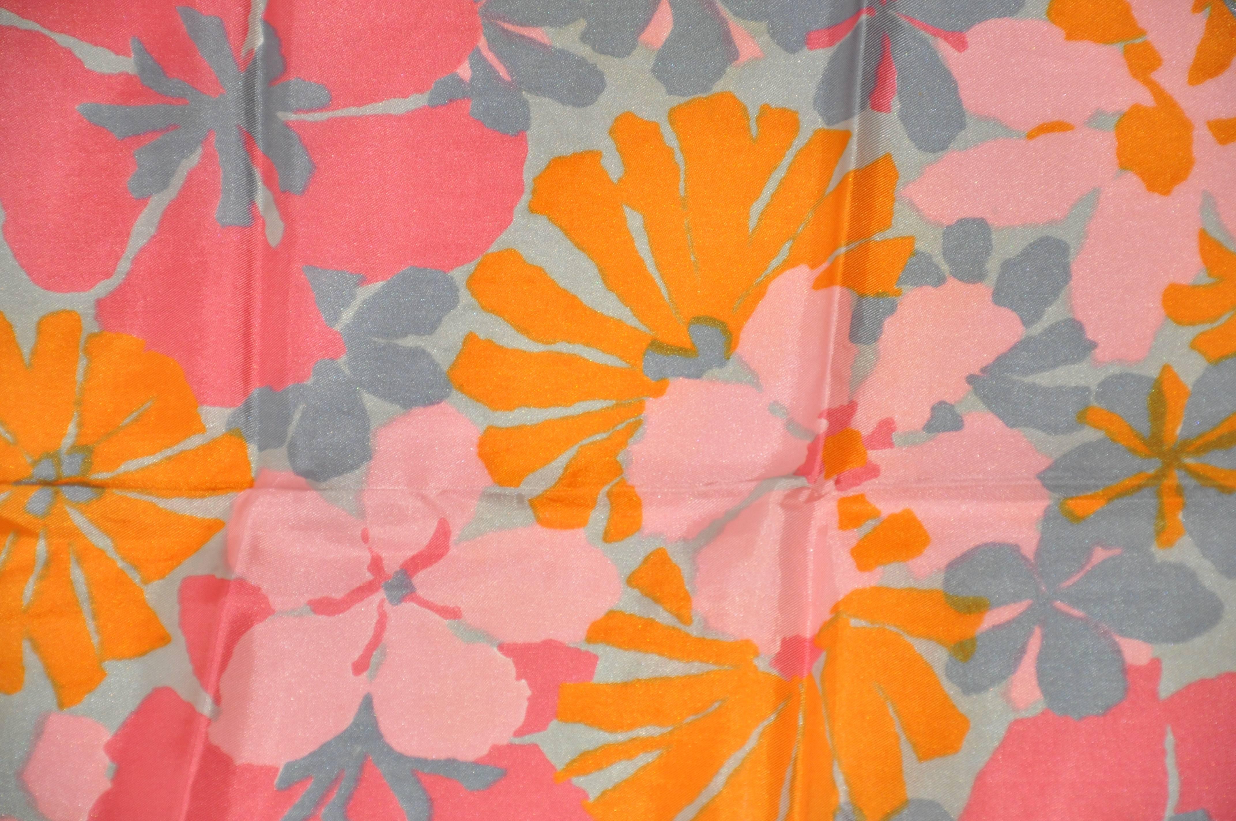Vera bold multi gray, rose, pinks and tangerine "floral" scarf measures 15" x 44". Made of rayon and silk from Japan.