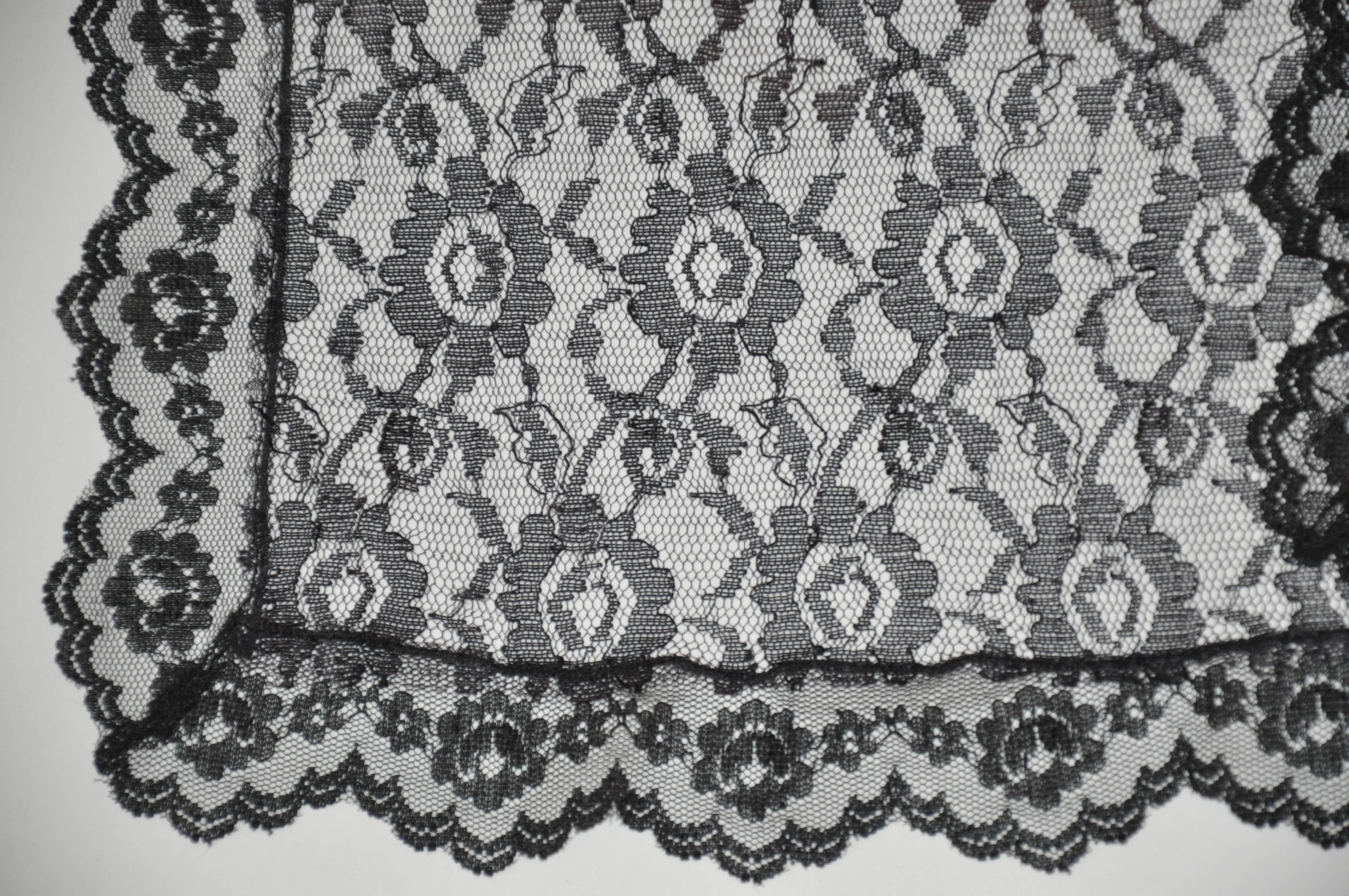 Black "Widow" lace floral rectangle scarf accented with lace border measures 15" x 60". Made in Italy.