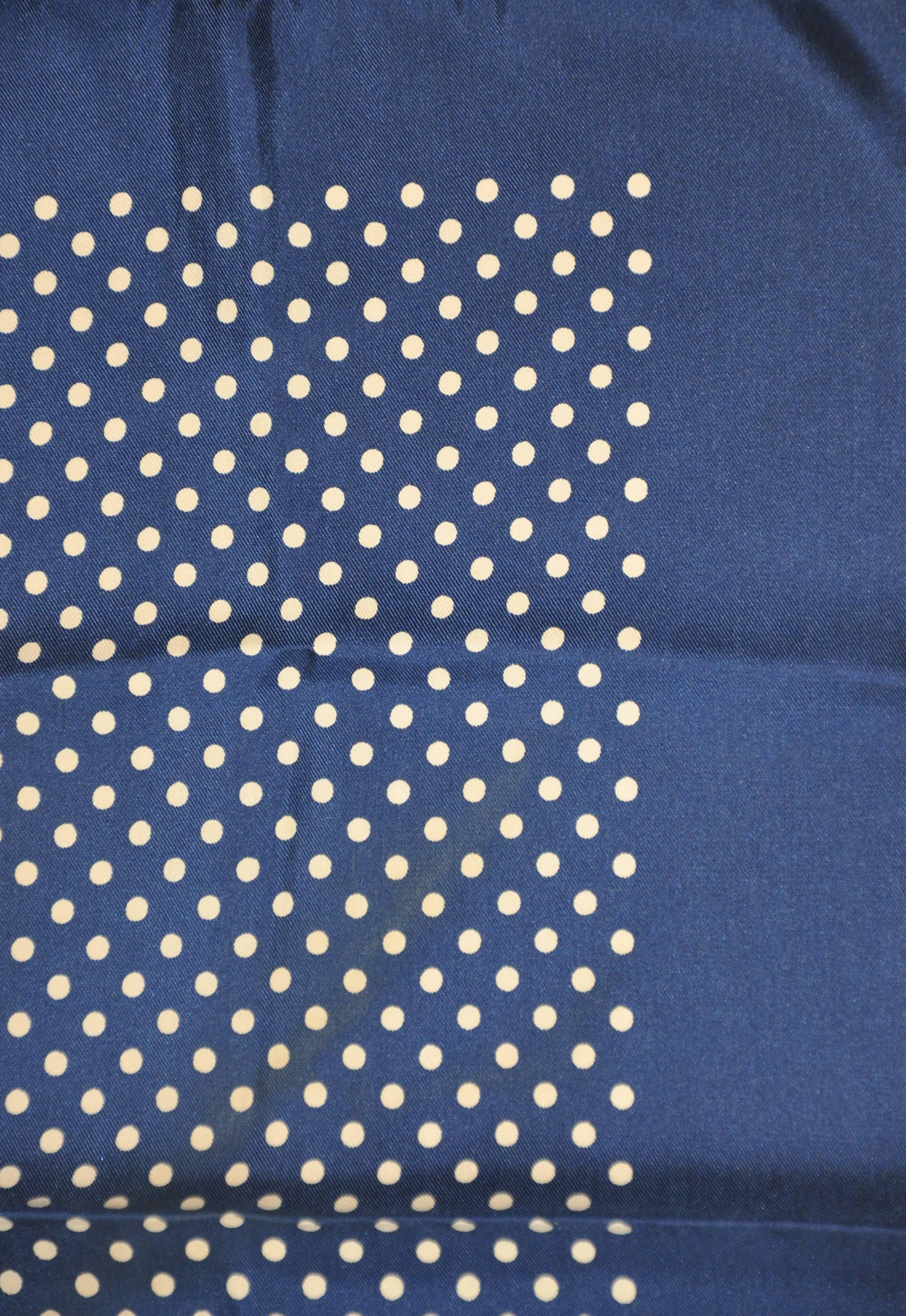 This wonderful classic navy & cream polka dot silk handkerchief measures 18 1/2" x 18 1/2", finished with hand-rolled edges. Made in Italy.