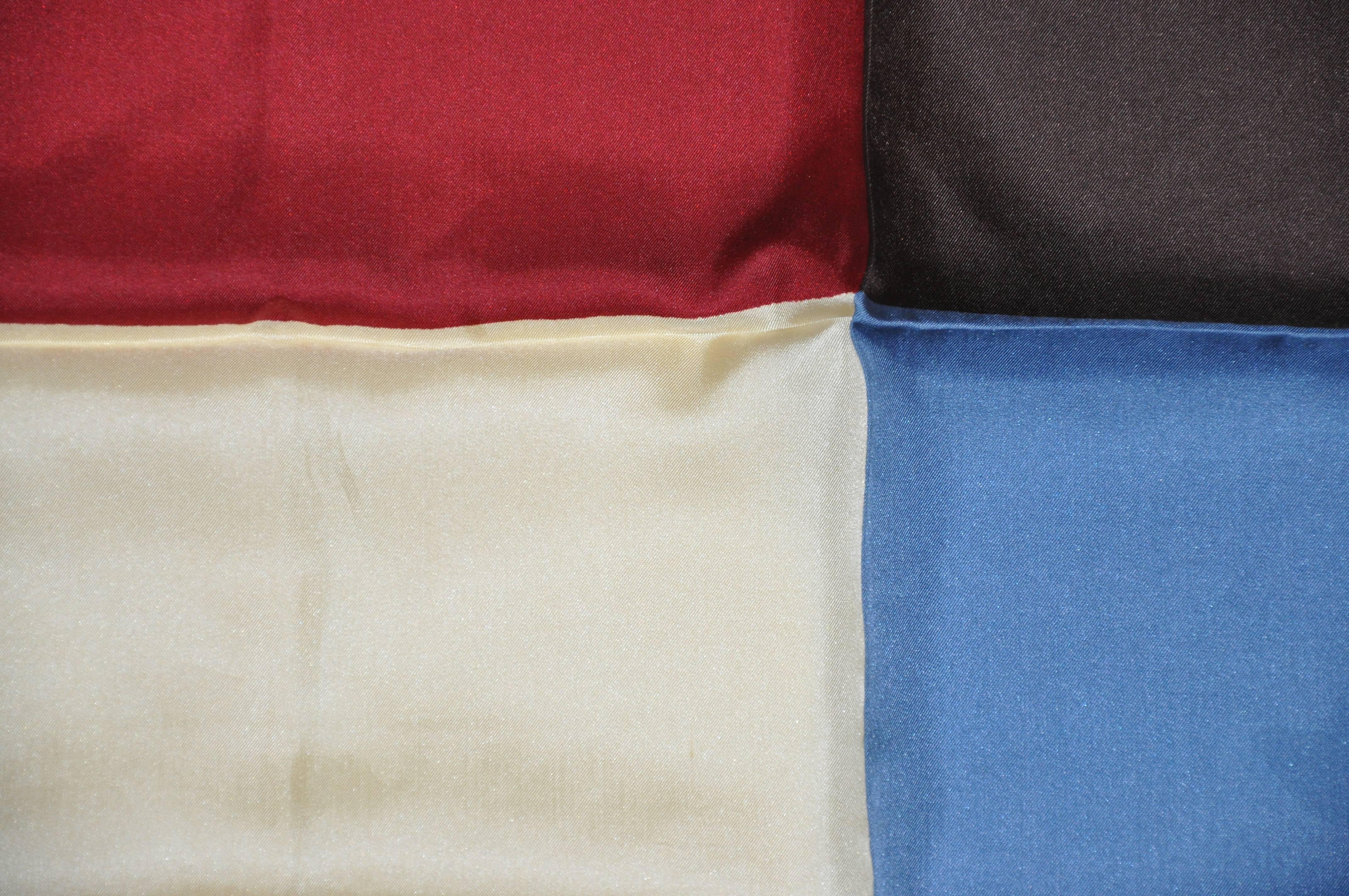 Bold burgundy, cream, blue and coco accented with black border men's silk handkerchief measures 19" x 19", finished with hand-rolled edges. Made in Italy.