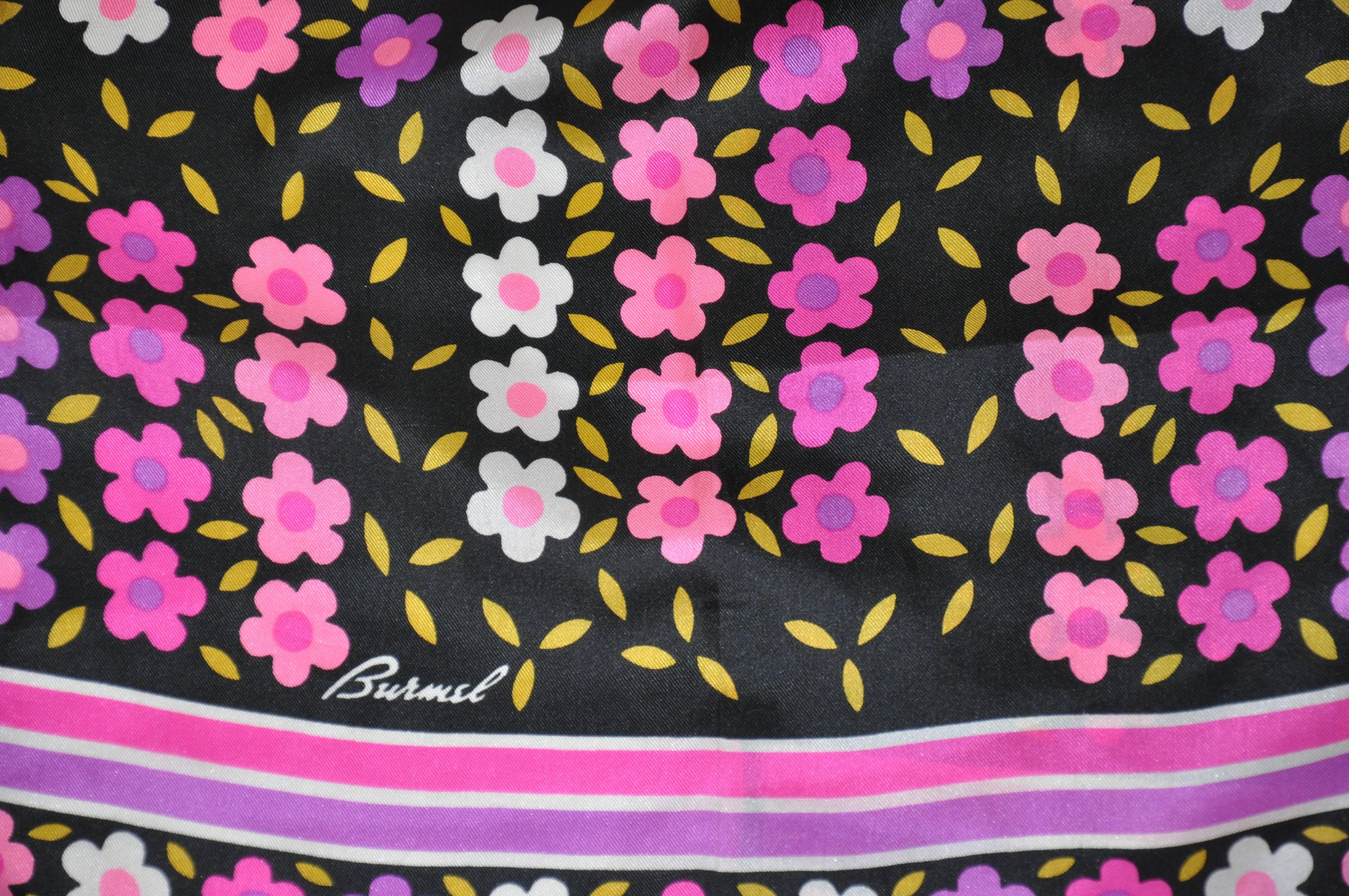 Burmel wonderful blend of violet, pinks and fuchsia multi-color floral accented with fuchsia borders silk scarf measures 13" x 46" and finished with hand-rolled edges. Made in Italy.