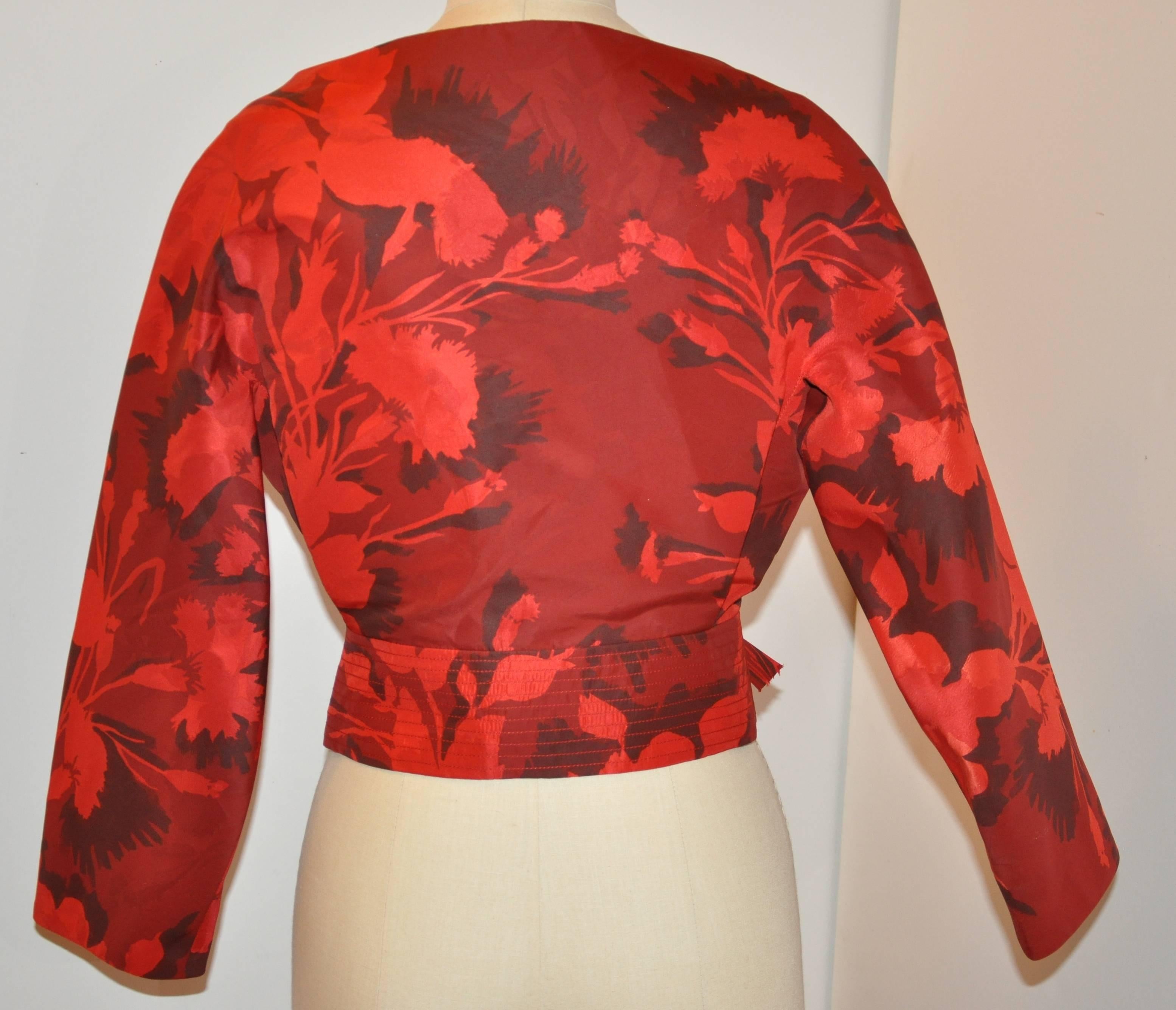 Carolina Herrera wonderfully elegant and timeless "Shades of Red" floral off-the-shoulder cocktail jacket is accented with lovely hand-made bows in front covering the four eyelet-and-round buttons as well as two snaps closings. The