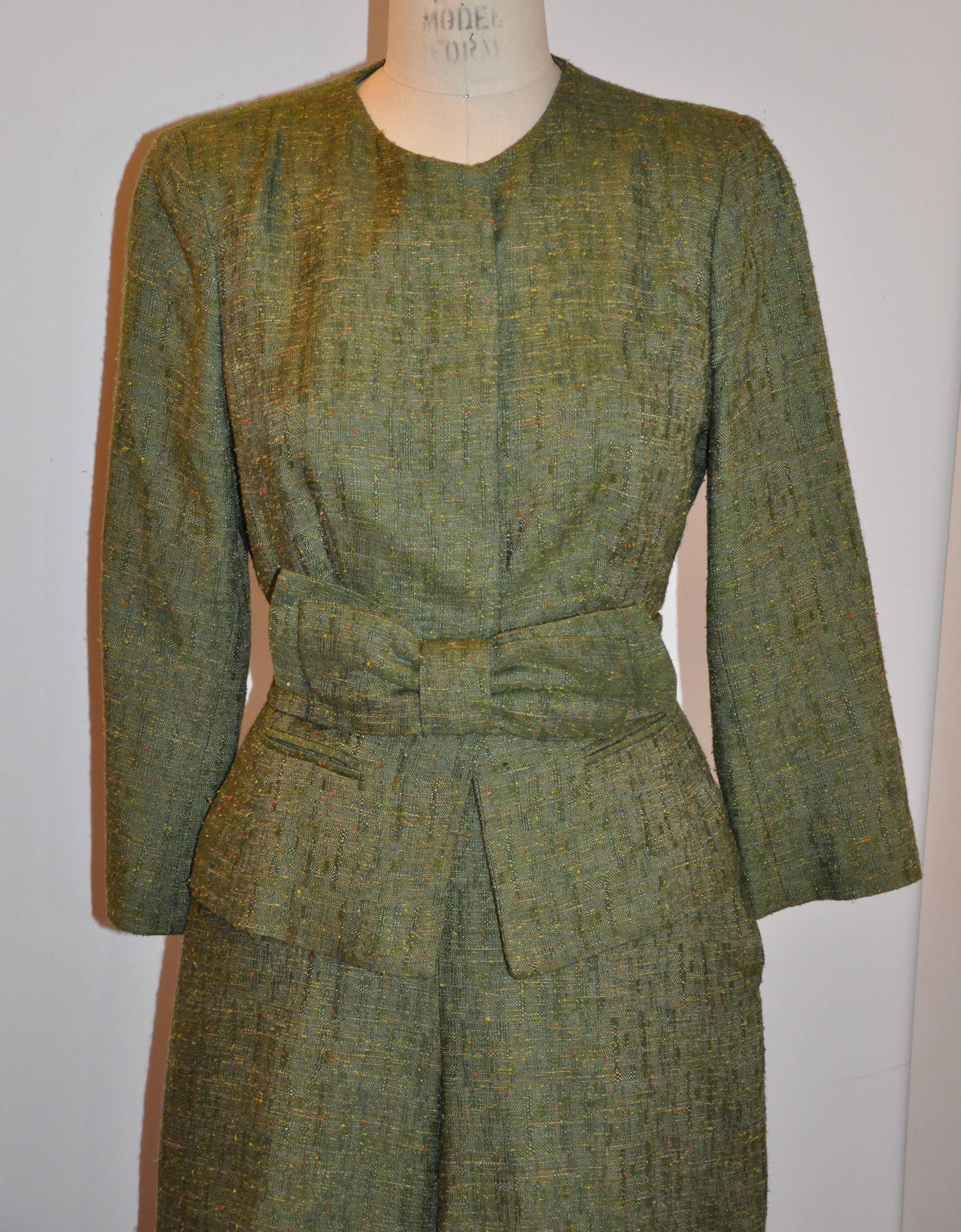 Oscar de la Renta wonderfully detailed olive-green three-piece blend of silk and linen consists of a jacket with hidden buttons, slim-cut trousers and a "Bow" belt which is optional in completely this ensemble. Jacket's interior is