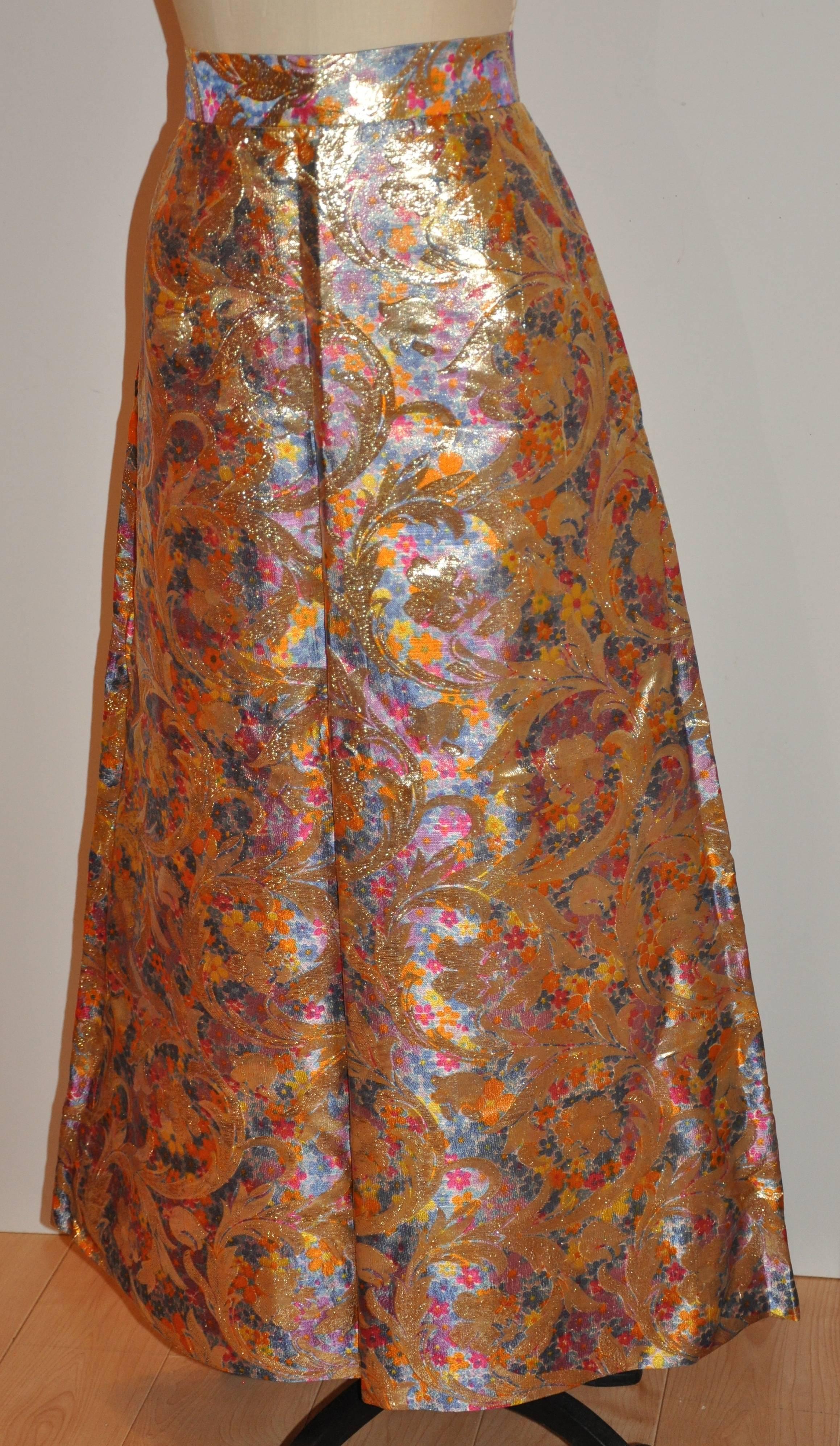 This wonderfully elegant silk brocade floral flare maxi skirt is accented with elaborate gold lame floral weave as well. The waistband width measures 1 7/8", waist is 30", hips are 49", length is 39 1/2", hem circumference is