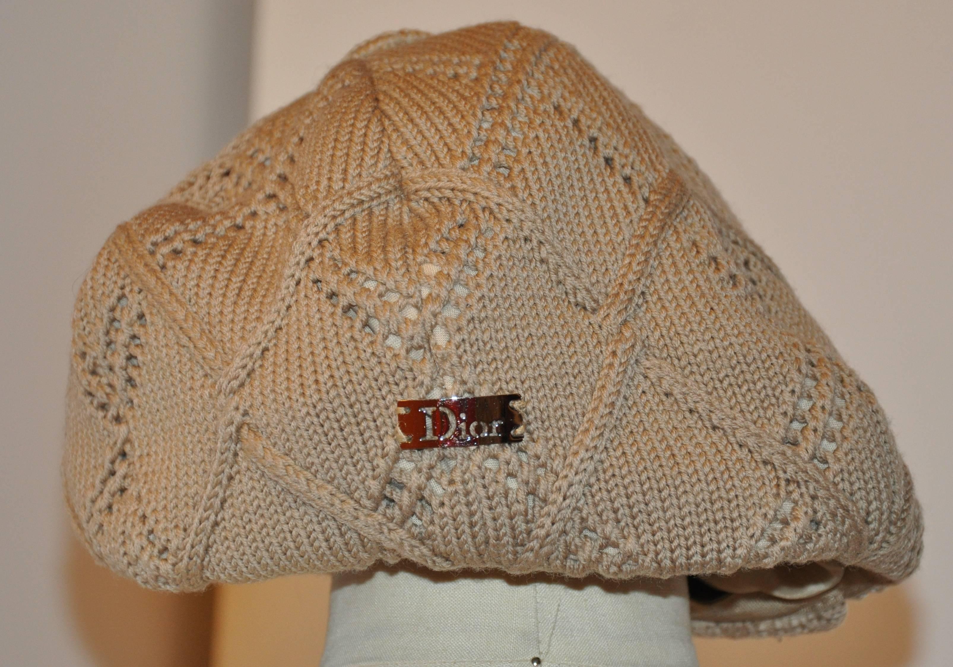 Christian Dior "Boutique" fully-lined woven beige "Newsboy" cap measures 23" in circumference on the interior. Fully-lined and accented with a 1" ribbon cord around the interior edge, the front extends 2 1/2", and