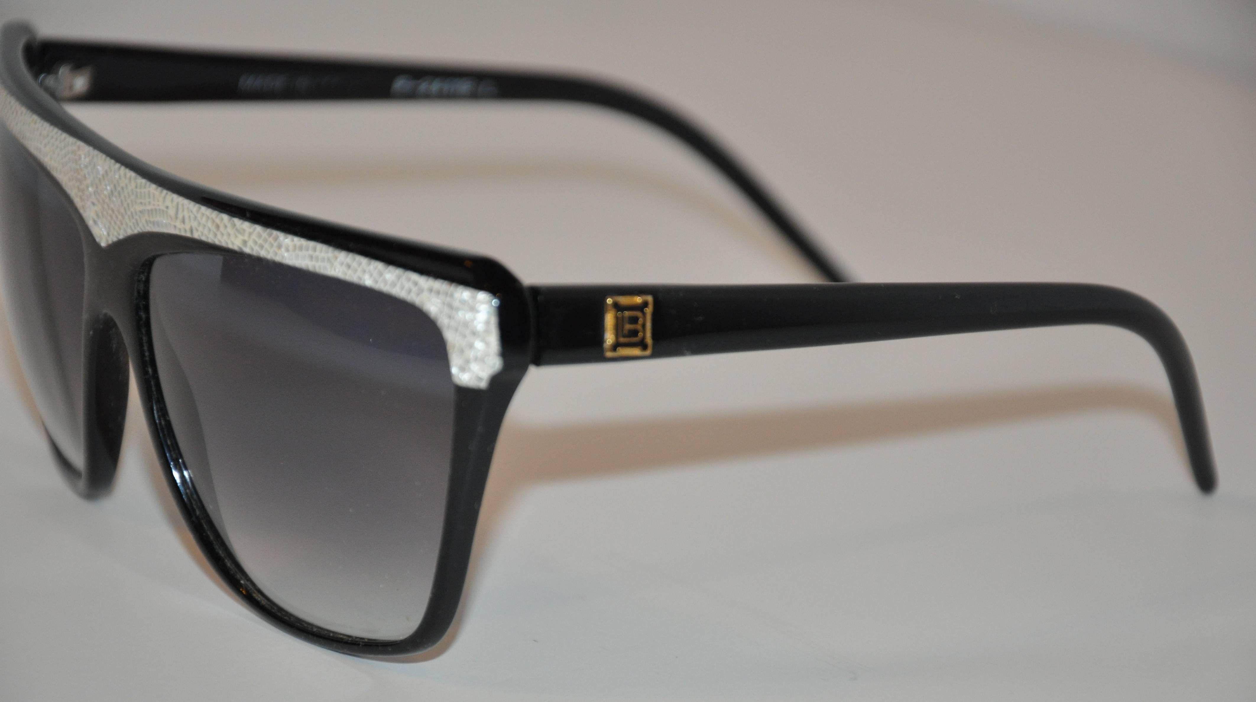 Laura Biagiotti wonderful combination of black lucid frames accented with gray & cream "snake" lucid on top of the frames measures 6" in width, 2 7/16" in height, and 5 1/2" in length on the arms. The arms are accented