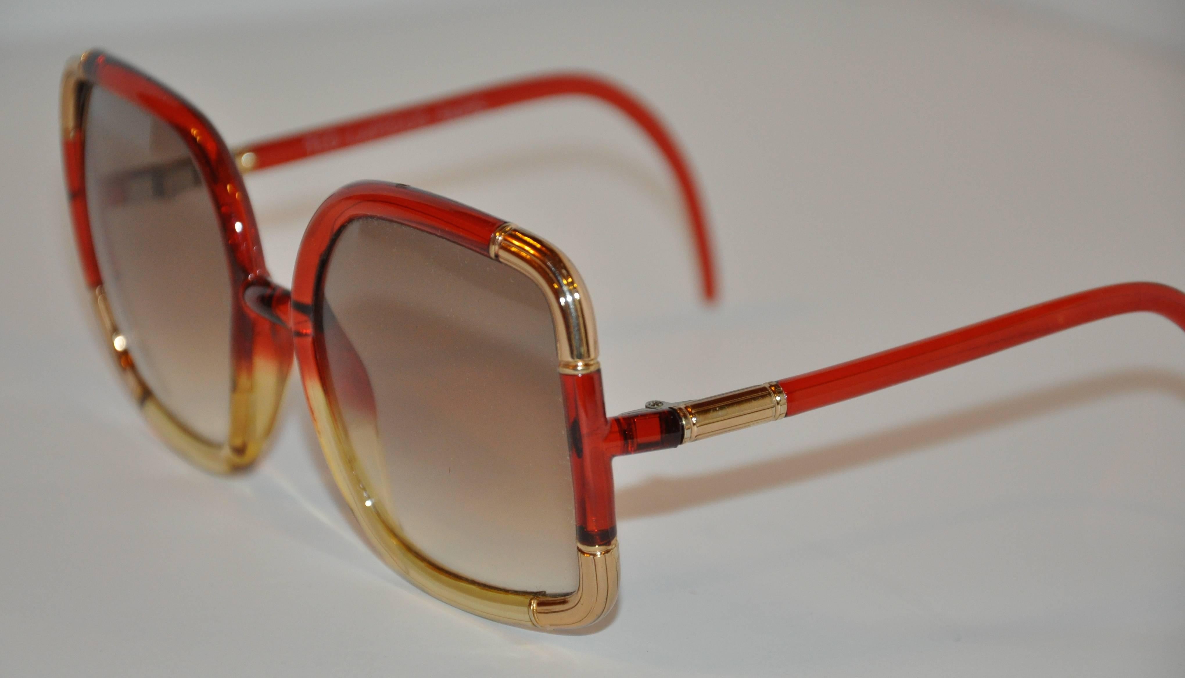 Ted Lapidus wonderful combination of red and gold lucid is accented with detailed engraved gold-tone 