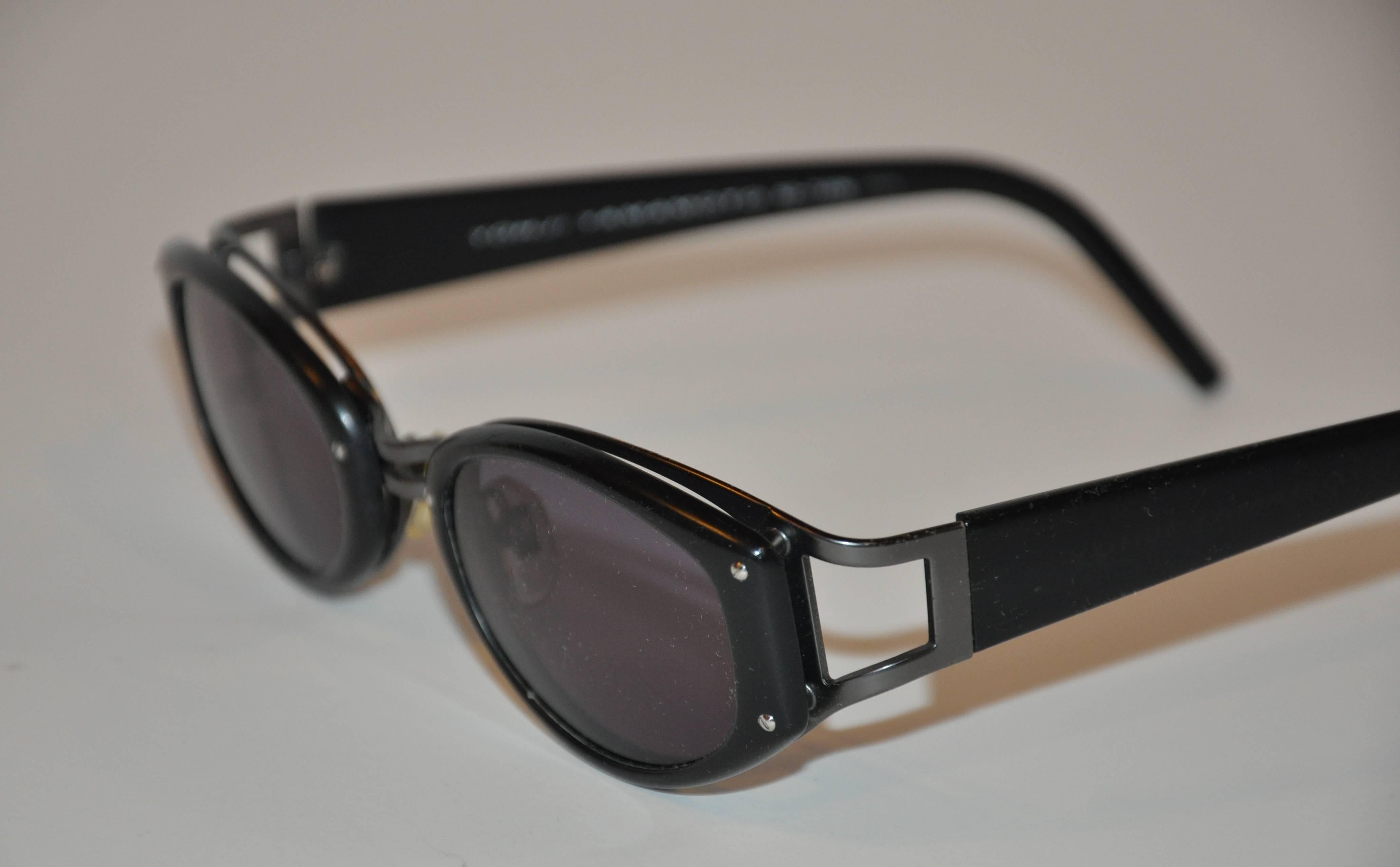 Yohji Yamamoto Wonderfully detailed double-frame sunglasses consists of one in matte black lucite and steel-gray hardware combined into one. Frames are accented with studs. The arms has the signature name on both sides. The front measures 5 1/2