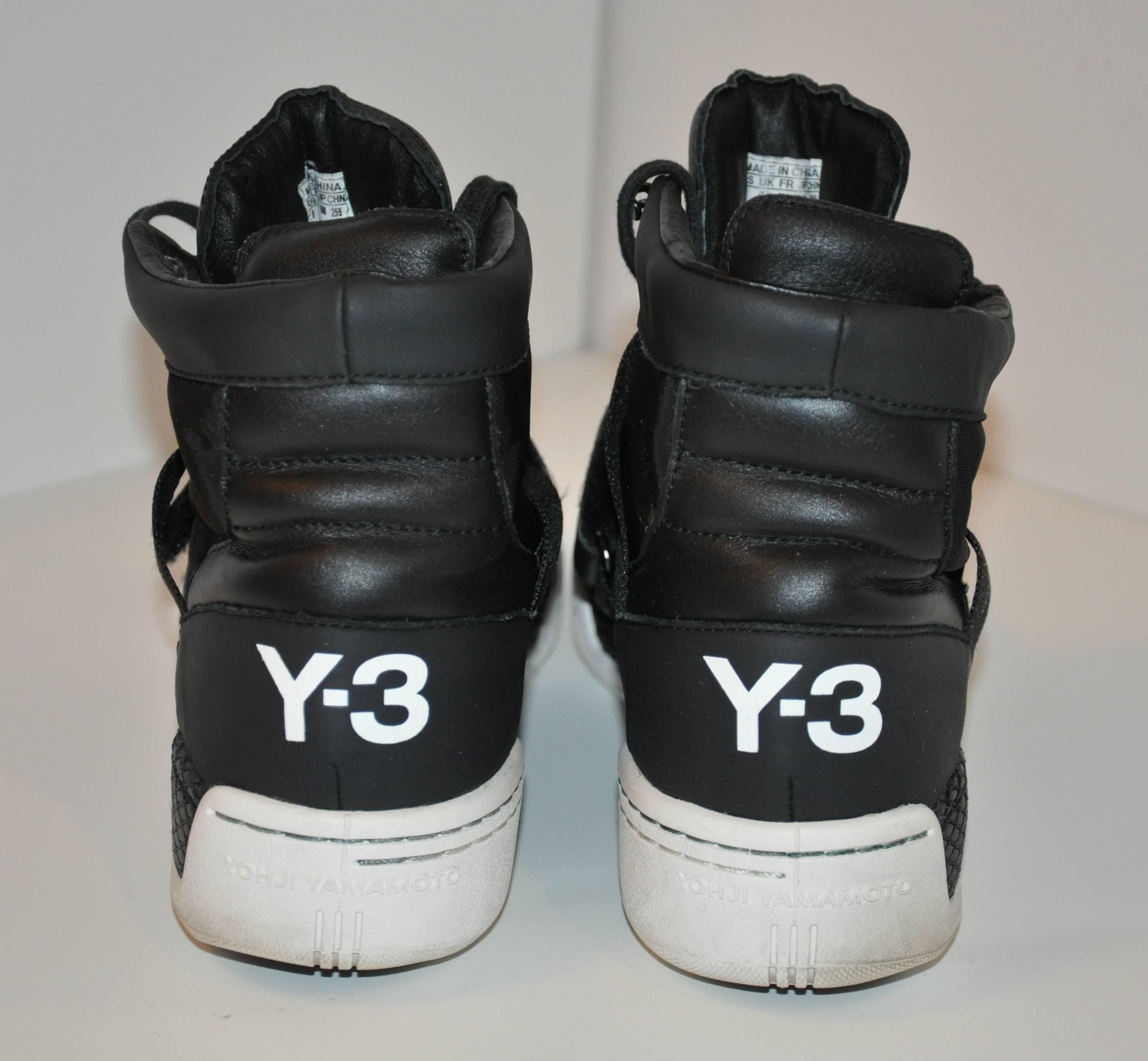 Yohji Yamamoto's wonderfully detailed black high-top lace-up sneakers has the option of an 