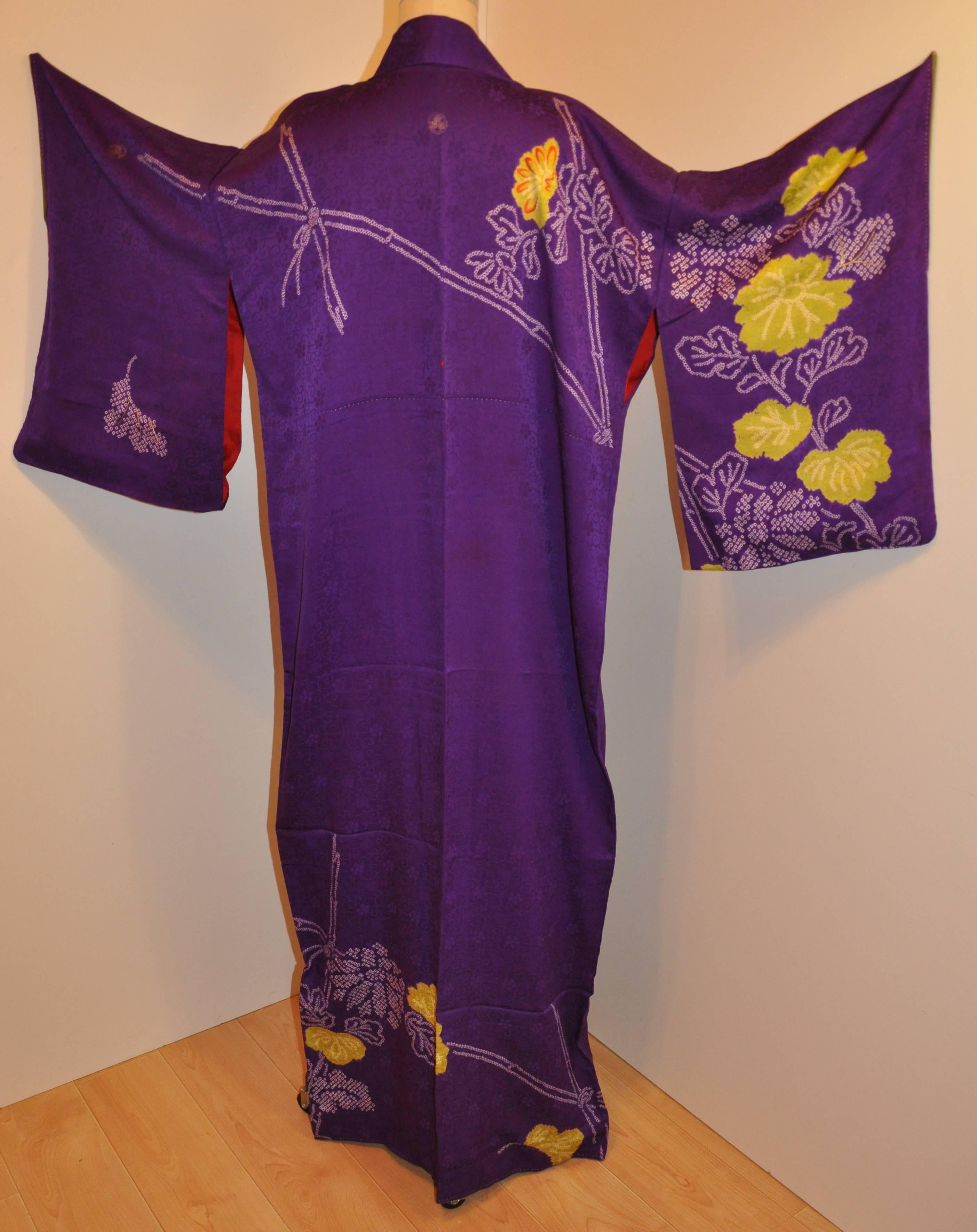        This wonderful elegant floral violet silk kimono is detailed with multi-colors of floral accented with hand-embroidered scattered on some of the floral. Gold and silver metallic also highlights the florals. The total length measures 59