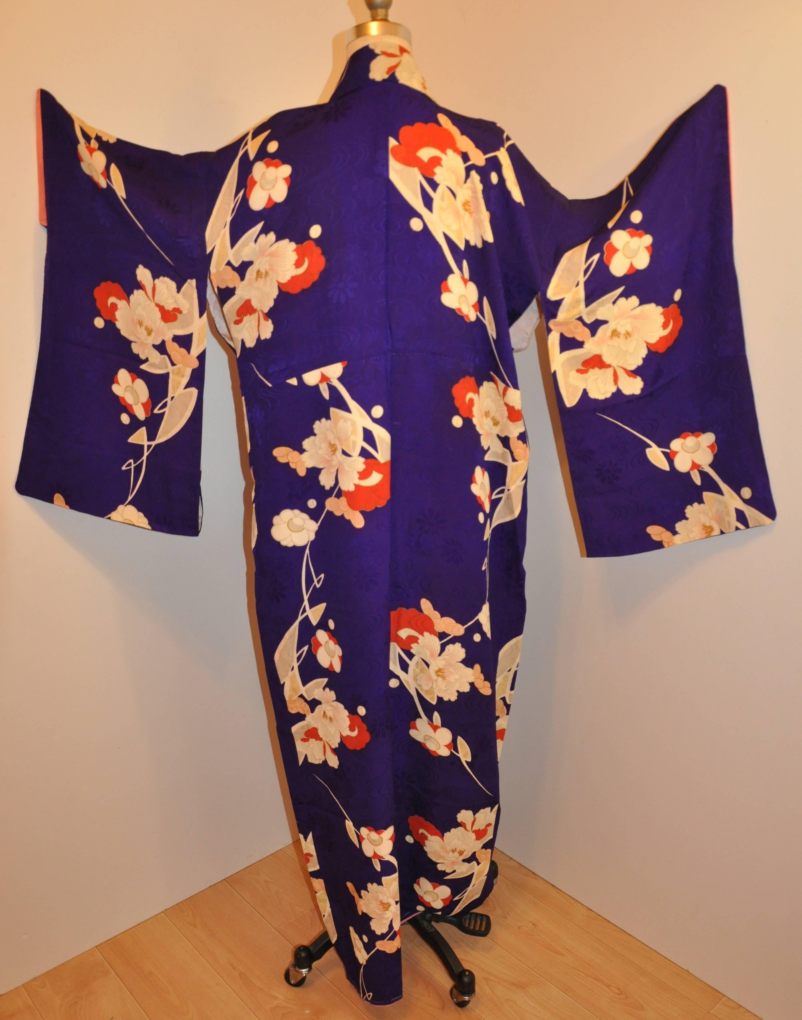      This wonderfully detailed purple silk kimono first has purple floral with the purple silk accented with multi-colors of florals in his hand-sewn Japanese Kimono. The length measures 58