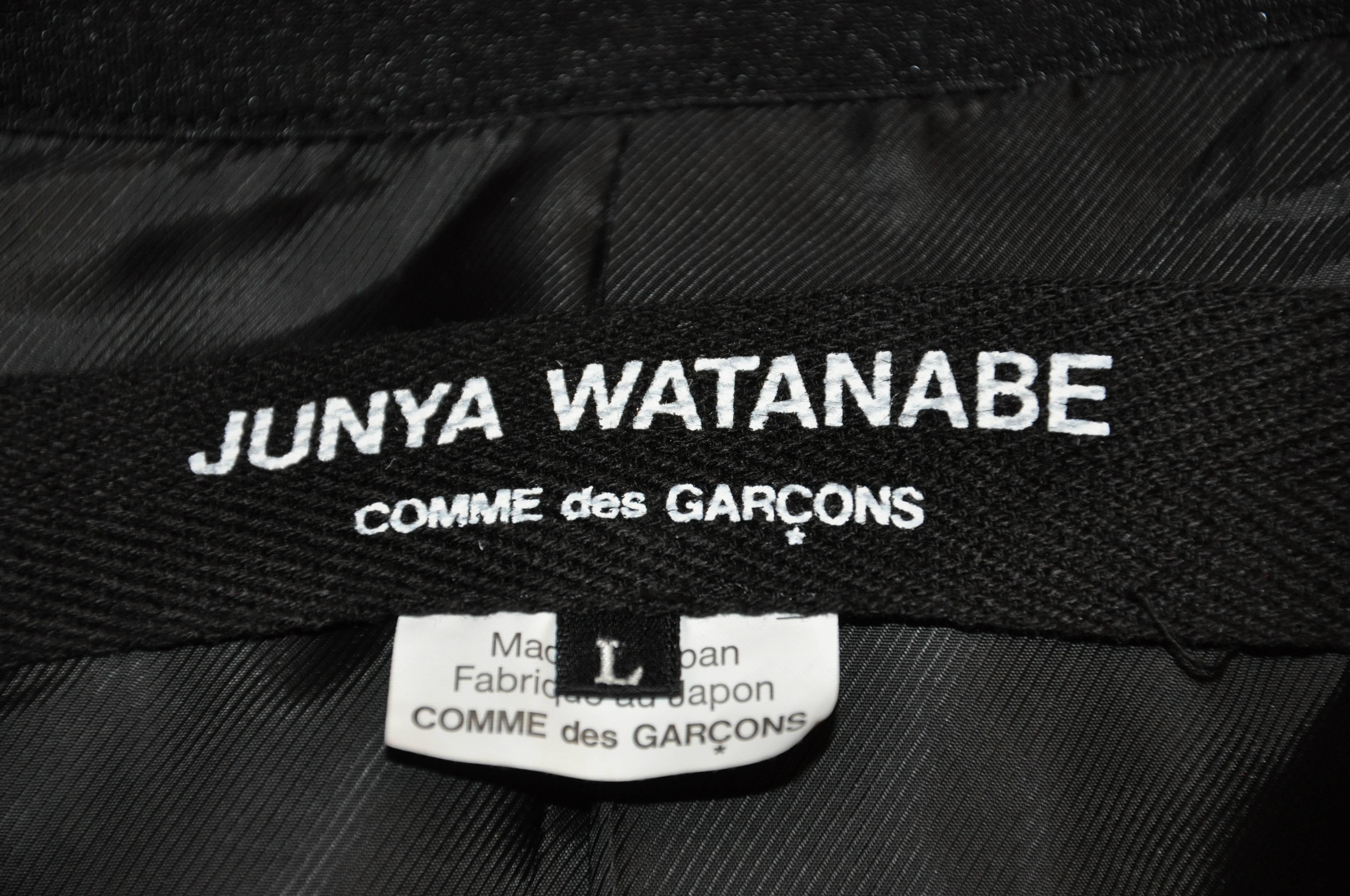       Junya Watanabe 'Comme des Garcons' wonderfully wicked detailed multi-textured black jacket has multi-textured three-front buttons with a hidden button on the lapel, as well as multi-textured three buttons on the cuffs. The multi-textured black