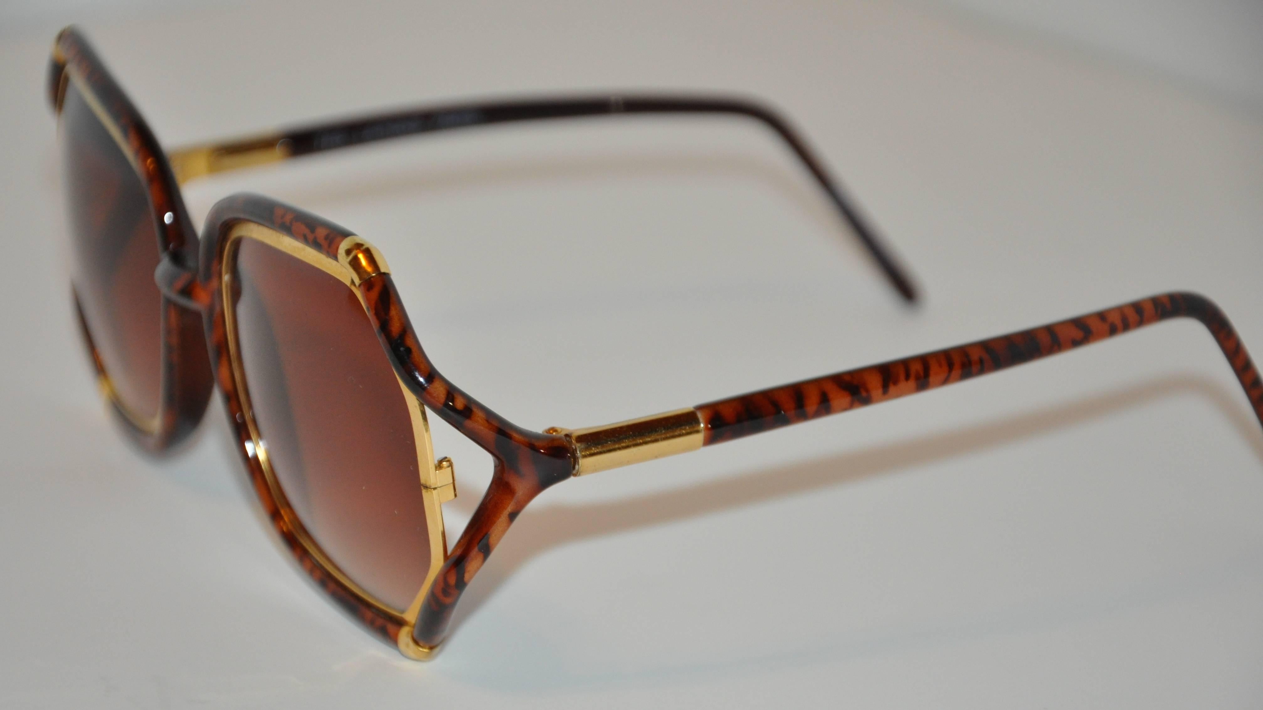         Ted Lapidus wonderfully elegant and vogue thick tortoise shell lucite sunglass are highlighted with gold hardware accent on both the front as well as the arms. The length measures 5 7/8" across the front, height is 2 3/8", arms are