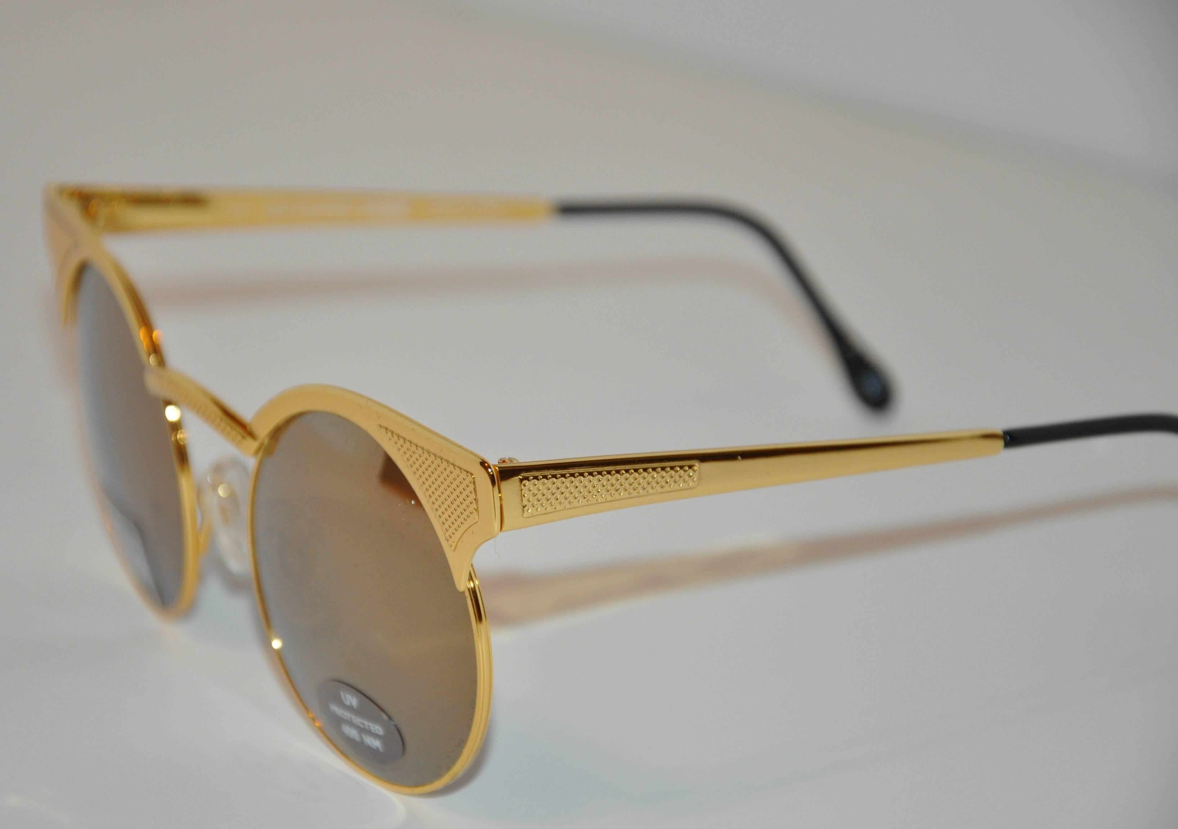        GianFranco Ferre wonderful combination of both polished and textured gold hardware frame sunglasses are finished with black lucite tips on the arms. The length across the front measures 5 1/4", height is 2", arms are 5" in