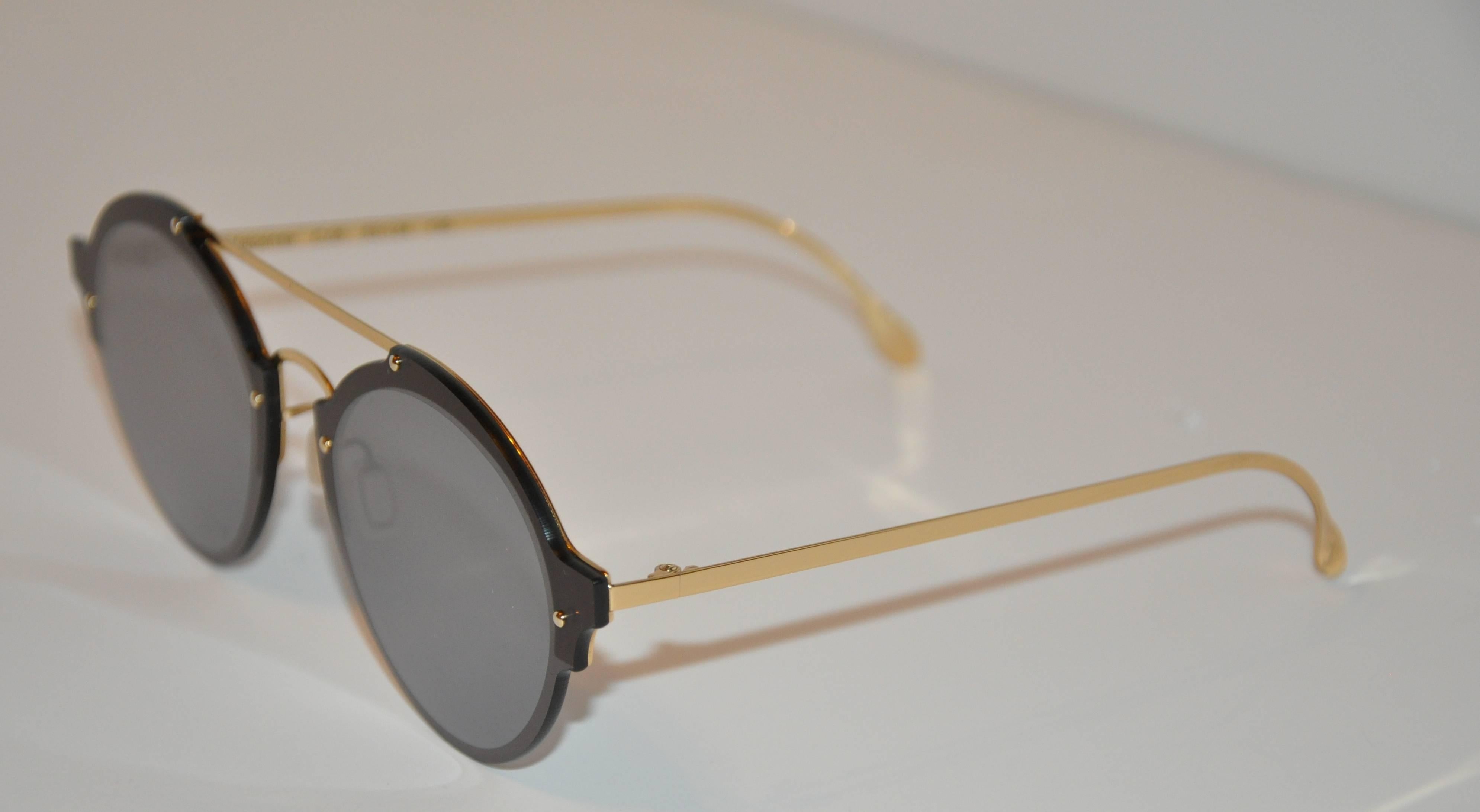 Illesteva detailed polished gold hardware hand-made frames are accented with gold studs. The front is finished with black frame surrounding the lens. The length across the front measures 5 7/8", height is 2 1/16", arms are 5 3/8" in