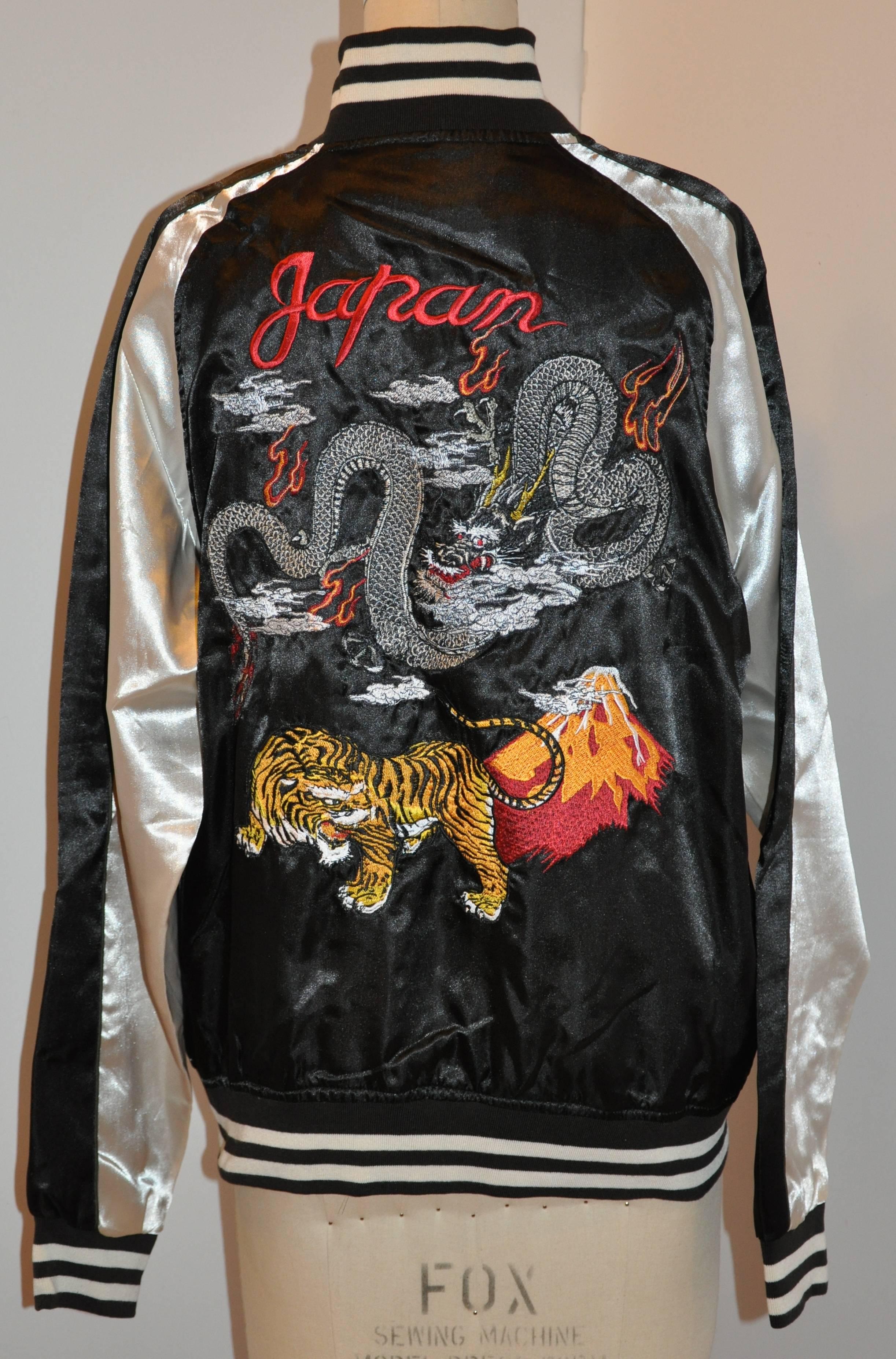       This wonderful Japanese ivory and black fully lined zippered bomber-style jacket is embroidered with Dragons and a tiger, finished with the words "Japan" in back. The collar as well as the hem is accented with a three-inch stripe