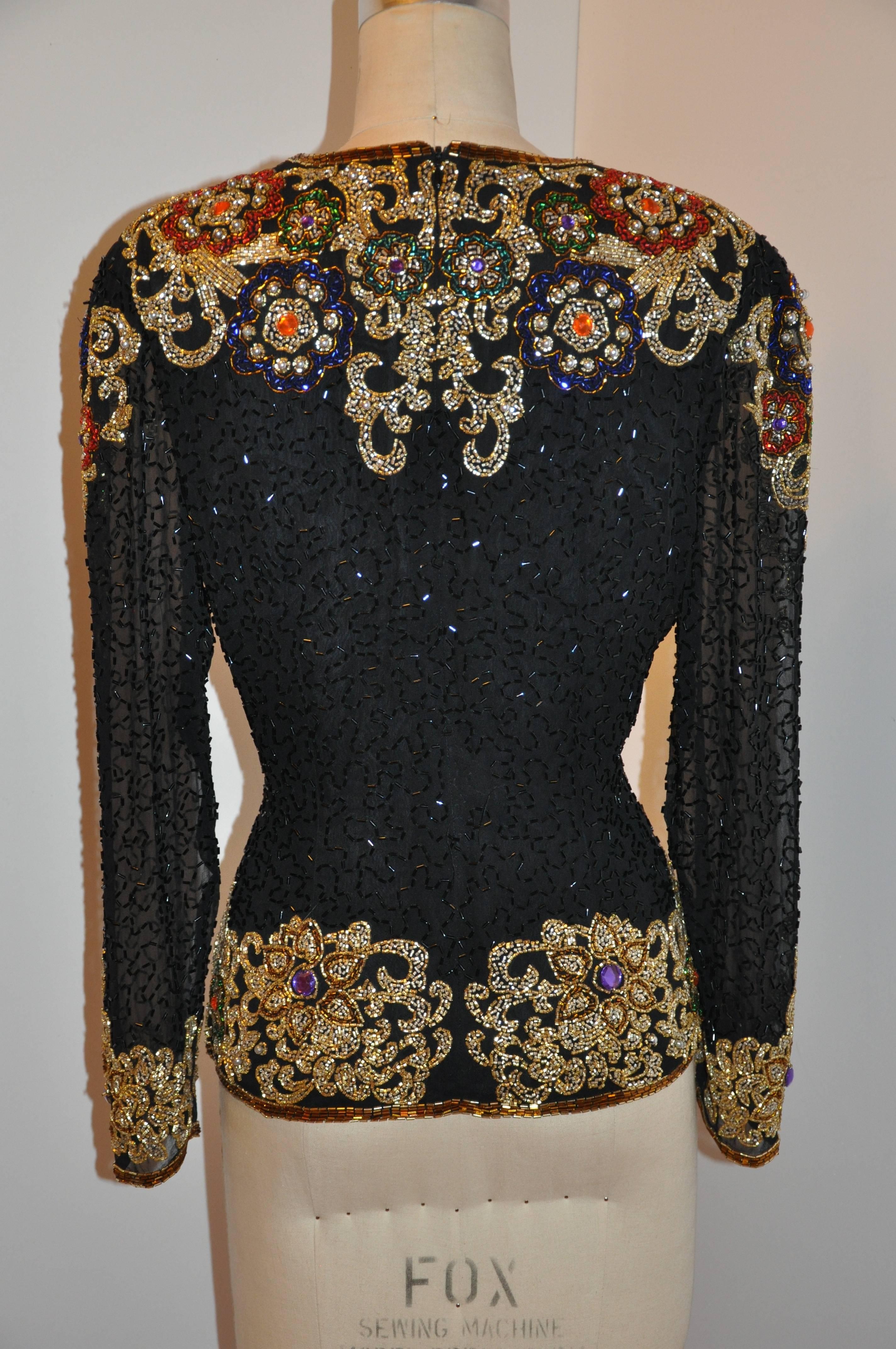 Oleg Cassini wonderfully elegant evening top detailed with multi-colors of  micro seed beading on black silk. The bodice is silk lined with matching black silk. The sleeves are detailed with sheer silk chiffon with detailed seed beading as well. The