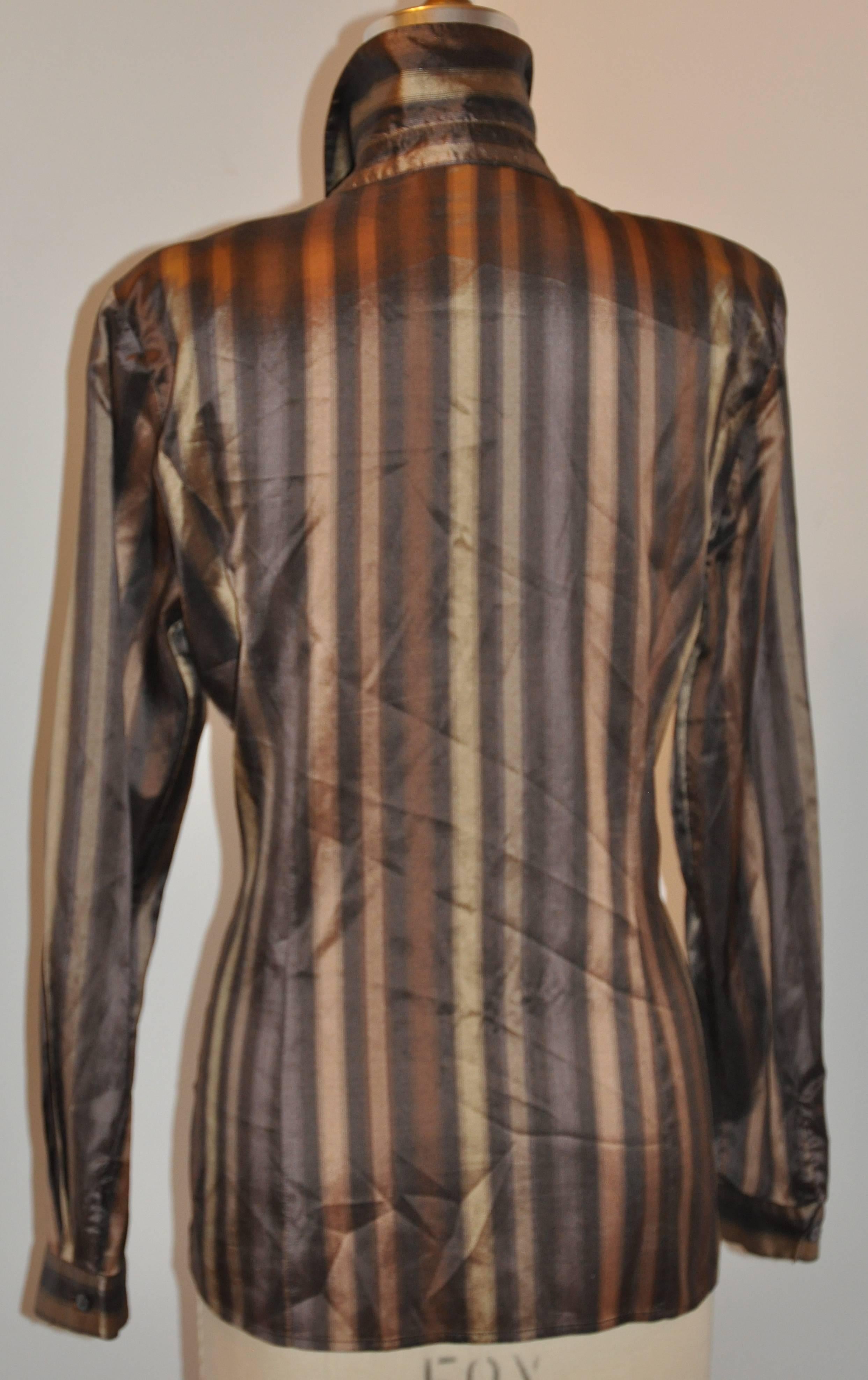        Jaeger wonderfully elegant Shades of bronze and gold multi-stripe silk button blouse has 8 buttons in front and measures 28 inches in length. There are two side slits measuring 4 1/4 inches as well as a single button on each cuff. The collar