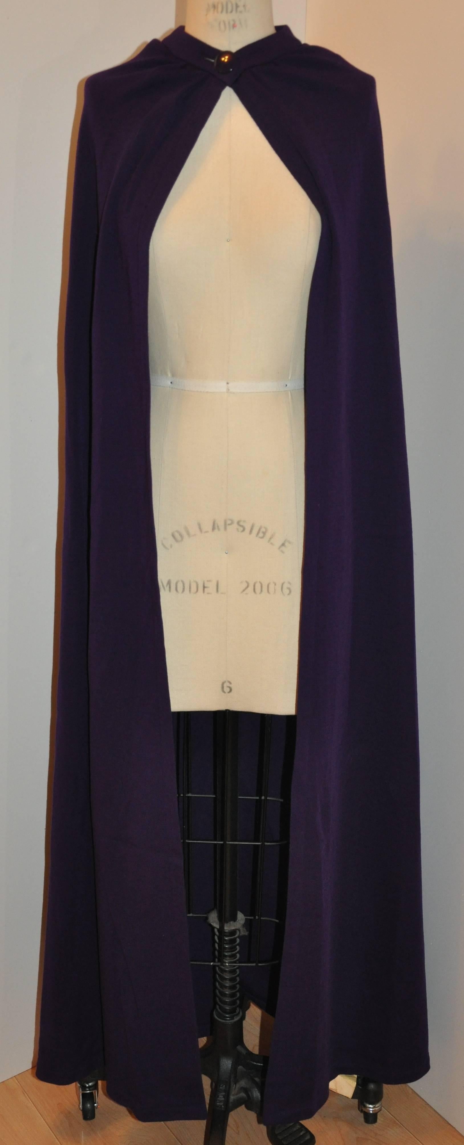        This rare Yves Saint Laurent Rive Gauche "Opium Collection's" magnificent and simply elegant deep violet wool jersey evening cape is detailed with a mandarin collar and accented with a simple button on the front center. This