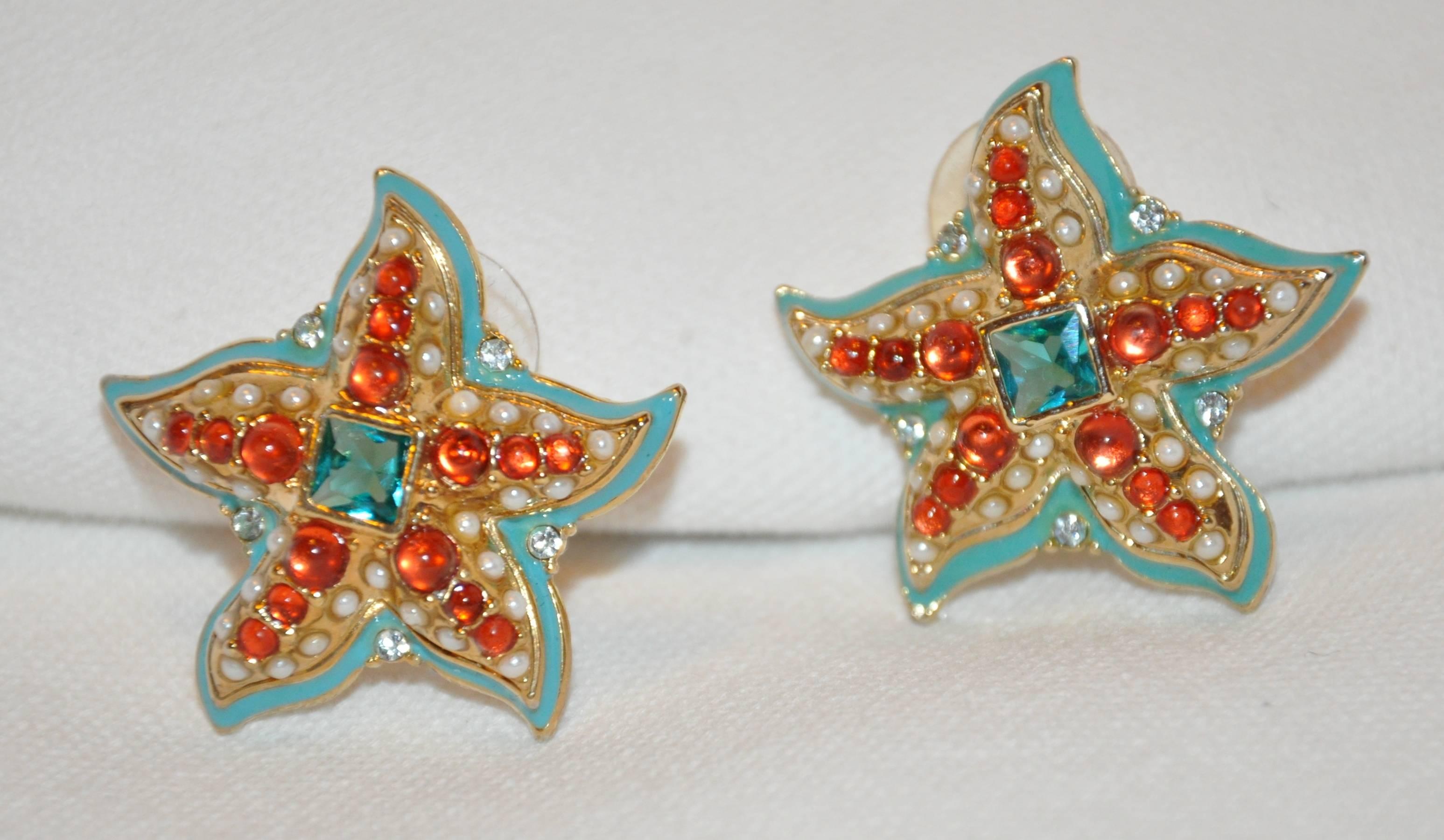         Kenneth Jay Lane wonderfully whimsical multi-color "Starfish" earrings of faux pearls, faux rubies, and faux emerald, surrounded with turquoise-hue enamel and set in gilded gold hardware. These earrings measures 1 1/4" x 1