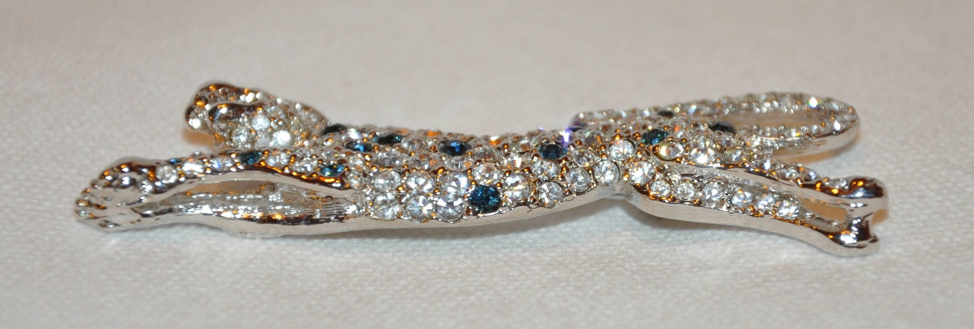        Kenneth Jay Lane wonderfully elegant Jaguar in polished silver vermeil finished hardware detailed with faux diamonds and faux sapphires makes for a chic brooch. The brooch measures 2 3/4" in length and 1" in width. Made in United