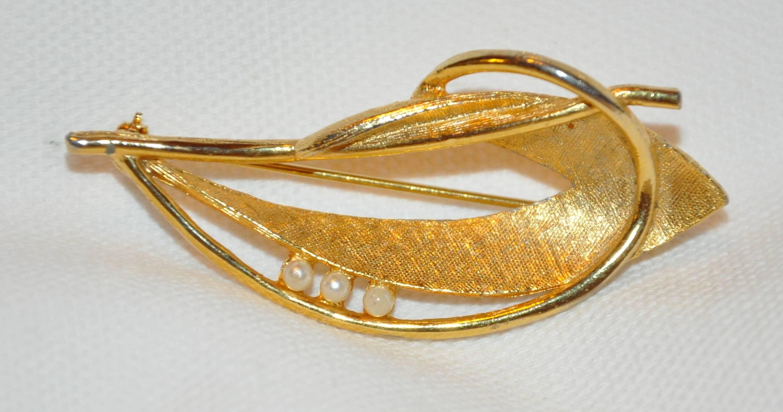        Wonderfully detailed with textured as well as polished gilded gold vermeil finished hardware "Leaf & Vine " brooch is accented with faux pearls, and measures 2 2/8" x 1", made in United States.