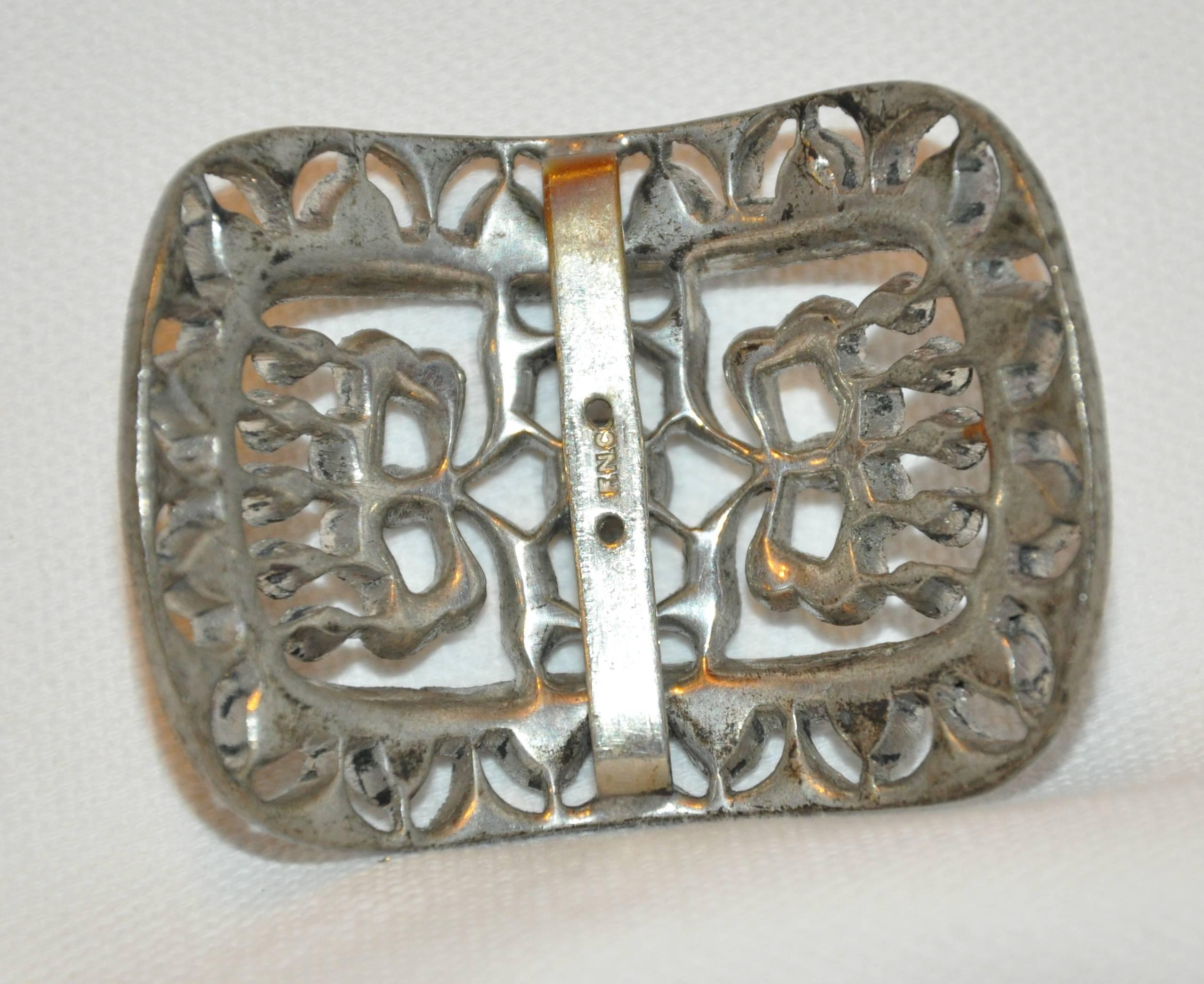        This beautifully detailed vintage gilded silver hardware belt buckle is accented with multi faux diamonds and highlighted with a single large faux diamond center. The buckle measures 2 1/2 inches x 1 1/2 inches. Depth measures 1/2 inch.