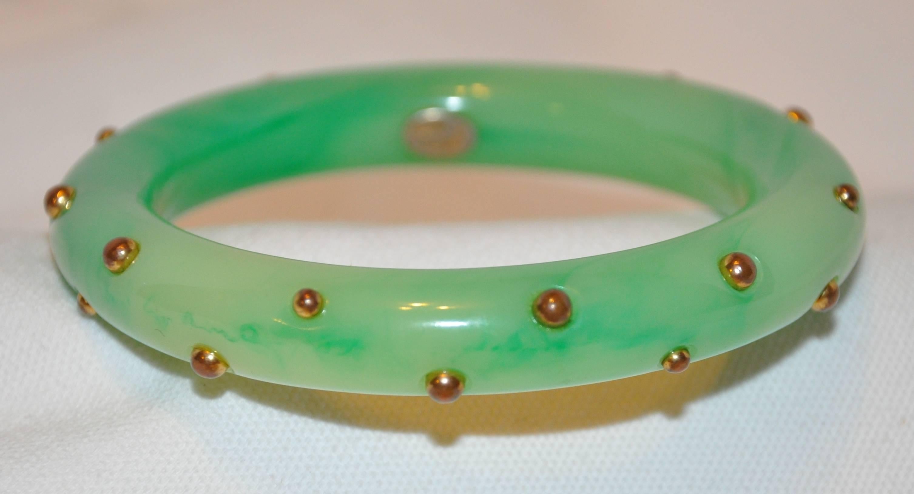        Kenneth Jay Lane wonderfully whimsical faux Jadeite is highlighted with gold hardware studs throughout. The interior circumference measures 8", exterior circumference measures 11 5/8", depth measures 9/16", made in United