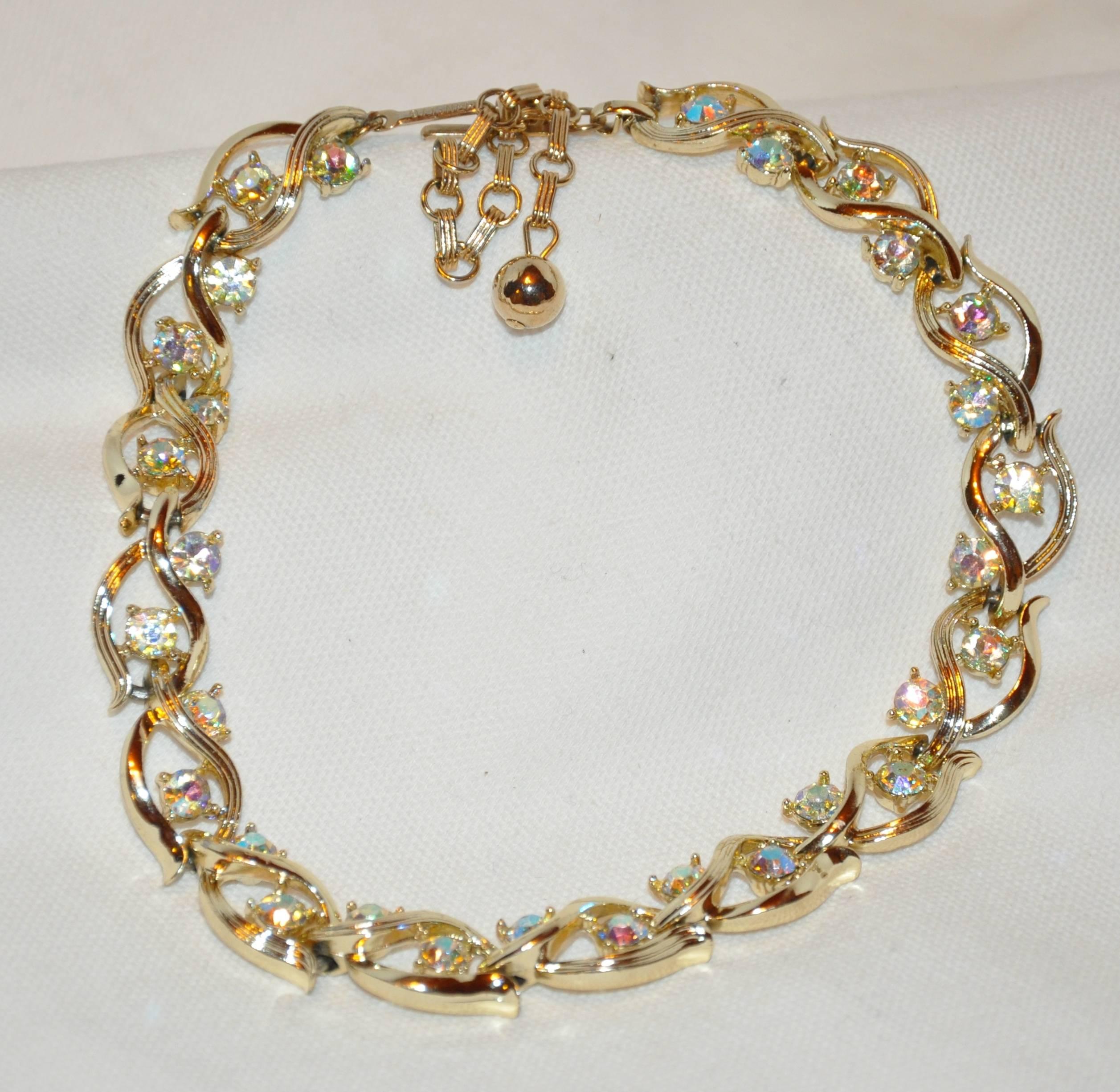          Lisner wonderful etched gilded gold vermeil finish hardware accented with multi-colored faux diamonds measures 12 1/2 inches to 16 1/2 inches depending how you desired the necklace to drape. The width measures 1/2 inch.