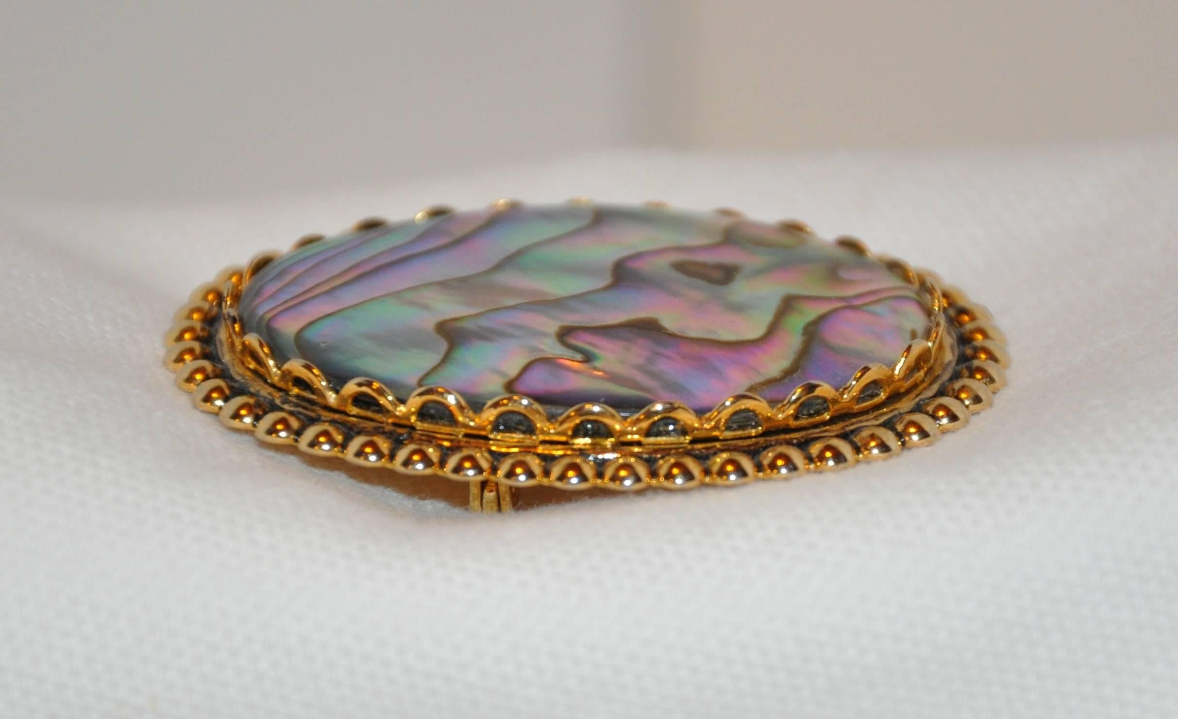      This elegant natural abalone brooch set with gilded gold measures 1 15/16 inches by 1 1/2 inches, made in US.