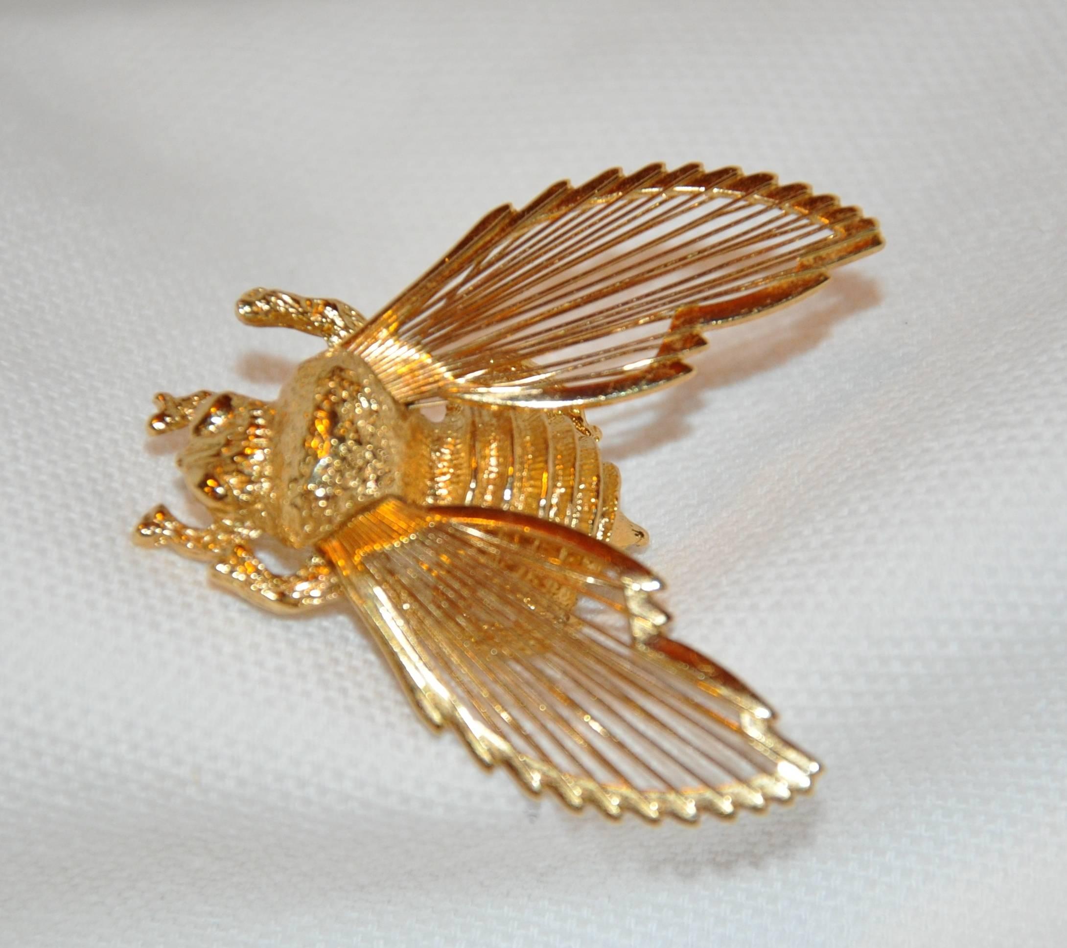        Monet wonderfully detailed gilded gold vermeil hardware "Bumble Bee" brooch is accented with detailed etching and wings resembling a set of musical harps. The length measures 1 1/2 inch, width is 1 7/16 inch, depth is 3/8 inch. Made