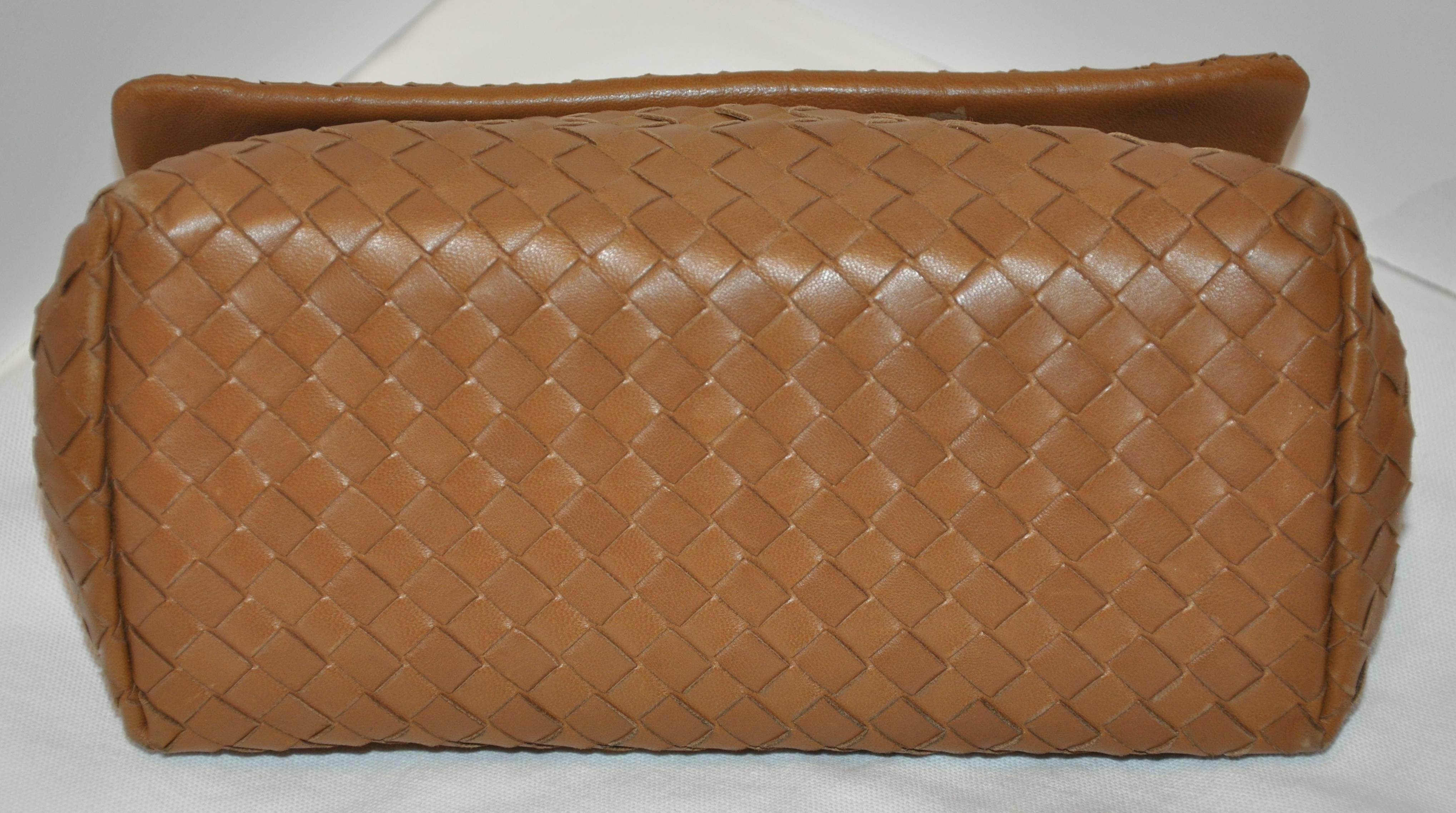          Bottega Veneta wonderfully elegant beige lambskin woven clutch has a two-sectional interior including a zippered compartment in-between. The flap-over closes with a magnetic center. The interior of the flap is slightly discolored (please