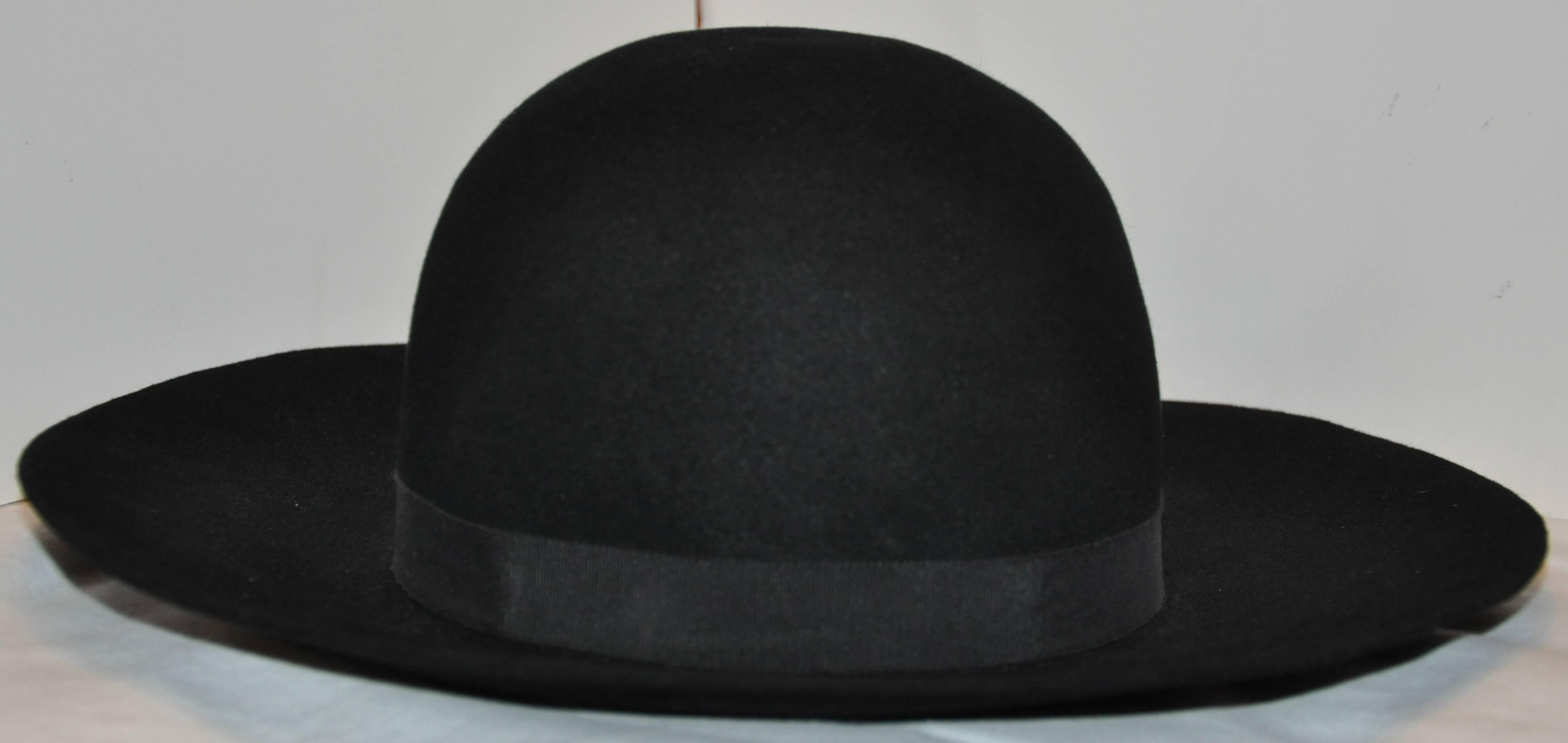        Yves Saint Laurent wonderfully elegant and classic black wool felt wide brim hat measures 6 inches in height. The interior circumference measures 22 inches, exterior wide brim circumference measures 45 inches, made in France.