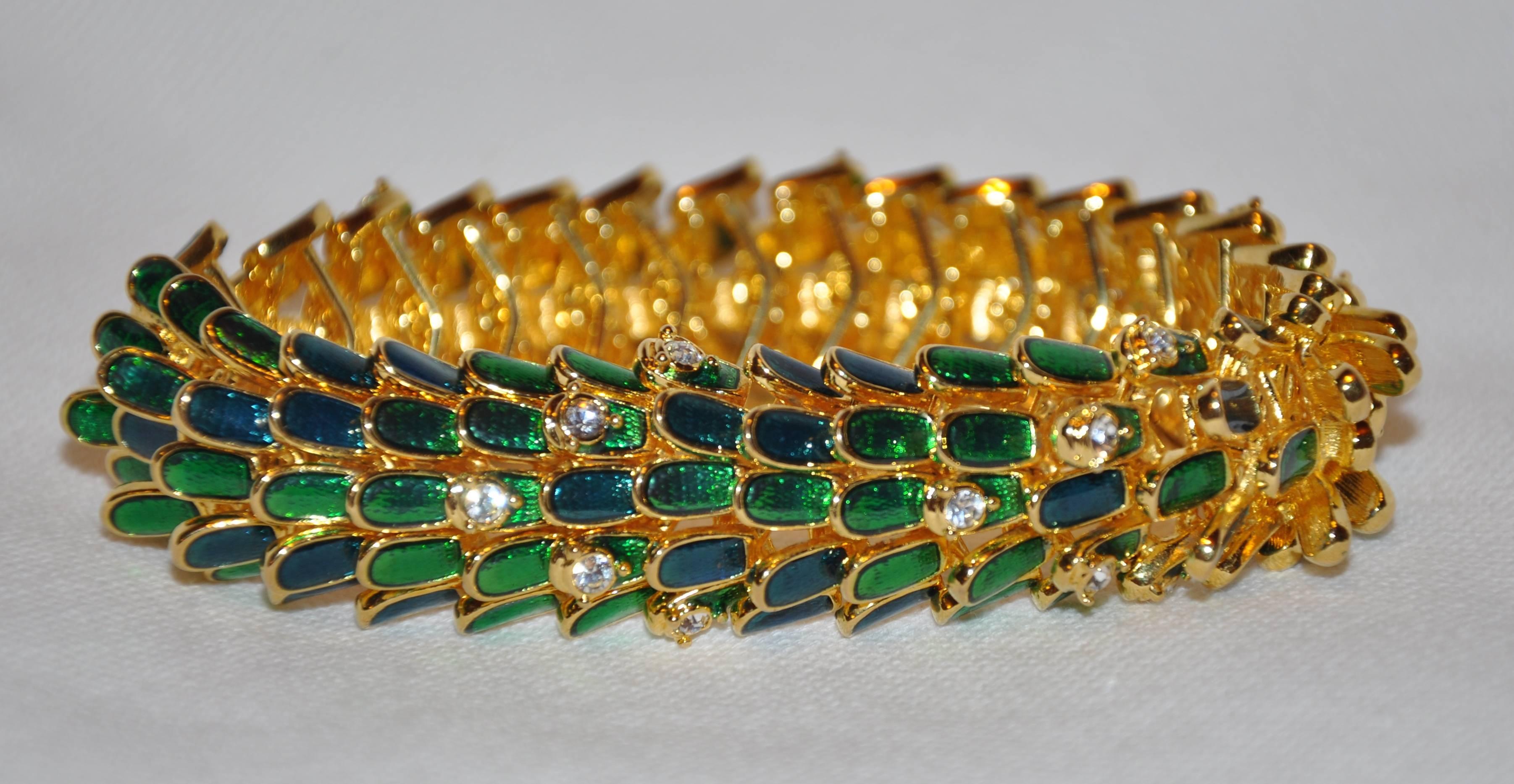        Kenneth Jay Lane wonderful polished gilded gold vermeil hardware bracelet detailed with bold rich green enamel is detailed with specks of faux diamonds. This wonderful bracelet drapes beautifully when worn. The interior is finished with