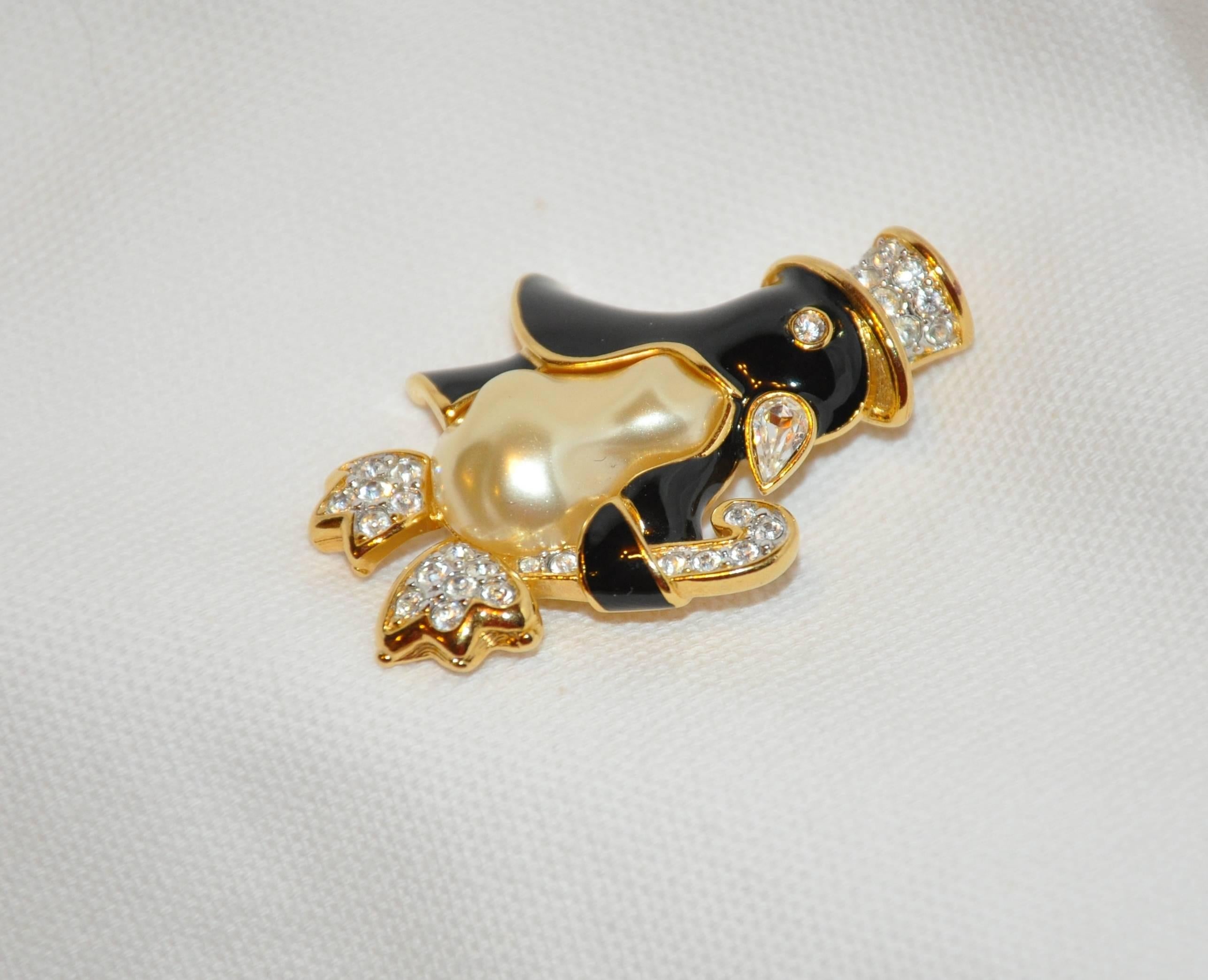        Kenneth Jay Lane's wonderfully whimsical "Penguin with Top Hat" brooch set in polished gilded gold vermeil hardware accented with faux pearl and faux diamond measures 1 6/8 inches in length, width measures 1 3/8 inches, depth is 1/2