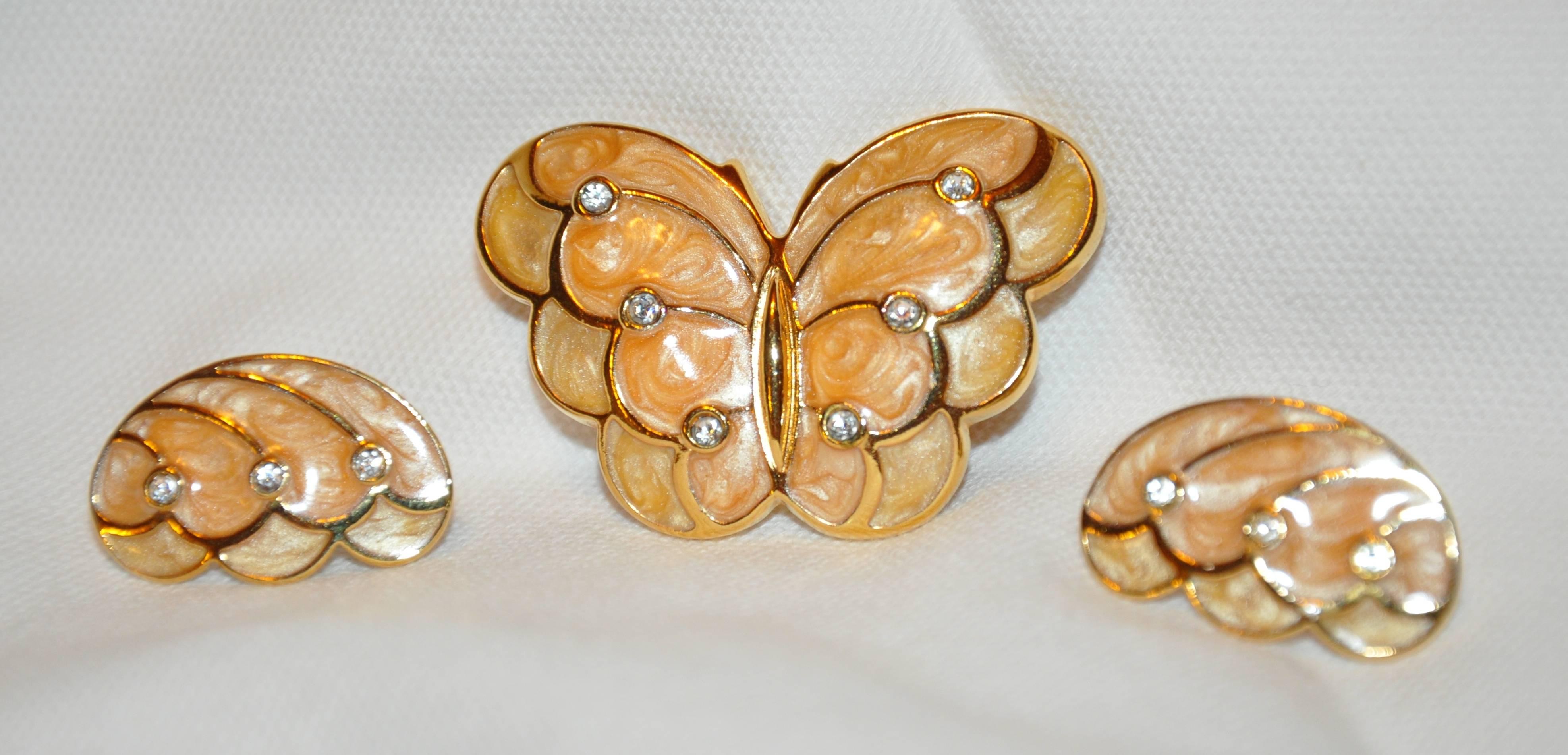         Kenneth Jay Lane's  wonderful gilded gold vermeil hardware accented with "Swirls" of enamel and finished with faux diamonds matching brooch and earrings makes for a elegant set. The brooch measures  1 7/8 inches x 1 1/4 inches.